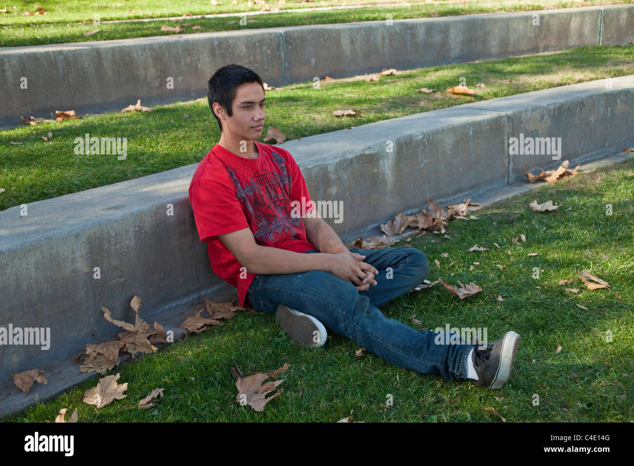 15-18 year old.Blackfoot American Native American meditating thoughtful alone park thoughtful dreaming side view full length MR  © Myrleen Pearson Stock Photo