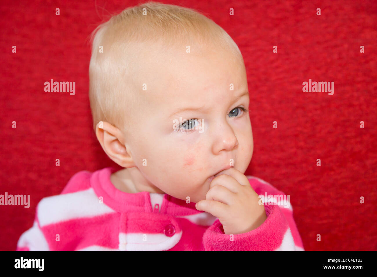 10 months old baby girl in pink pyjama Stock Photo Alamy