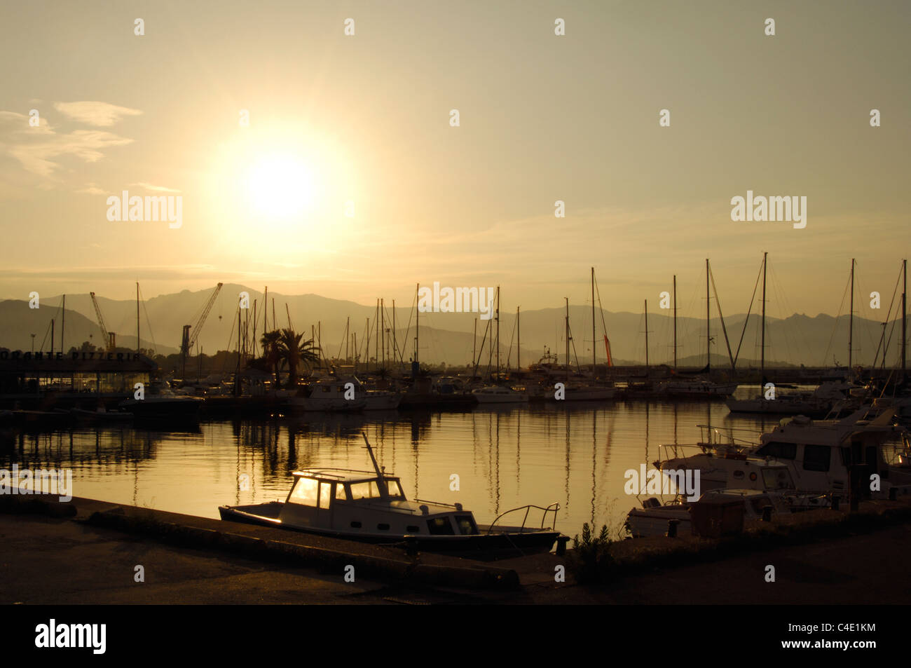 Sunset and yachts at the Arbatax touristic port, Ogliastra region, Sardinia, Italy Stock Photo