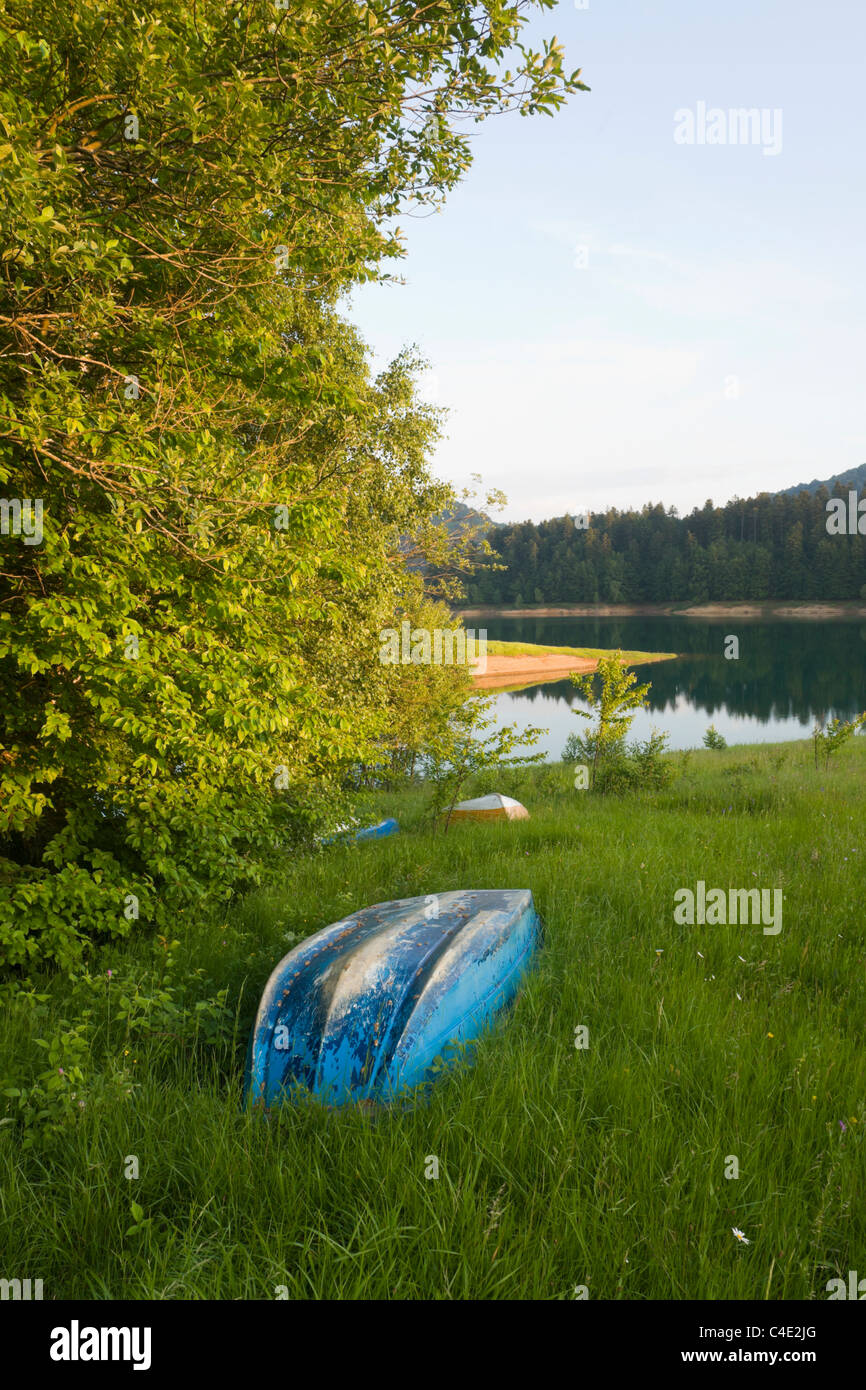 Boats laid ashore on the grass,  Lokve lake in Gorski Kotar, Croatia field lakeside Primorje-Gorski Kotar County in on at probably but near evidently Stock Photo