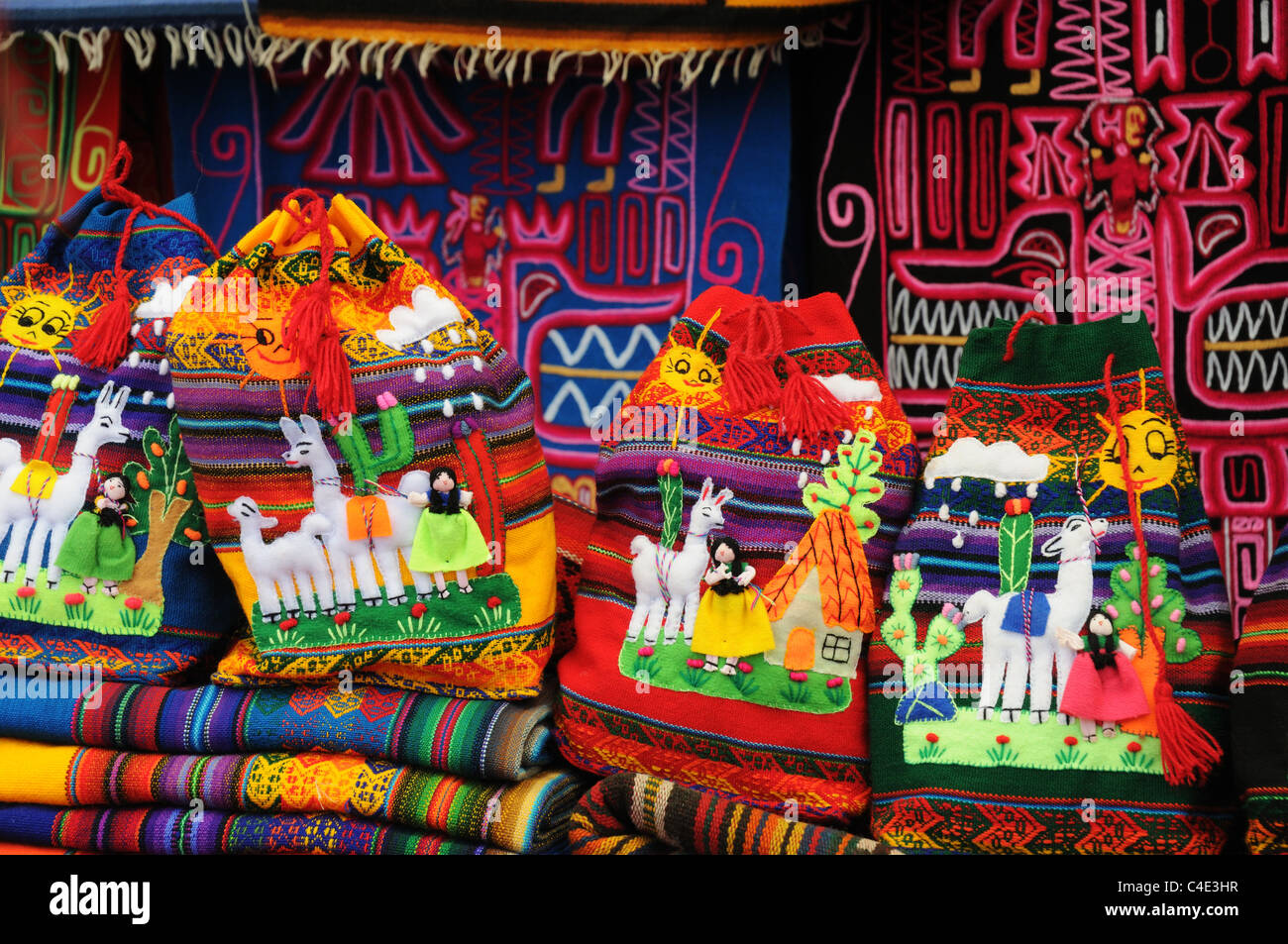 Brightly coloured cloths and tapestries for sale on the market at Pisac in Peru Stock Photo