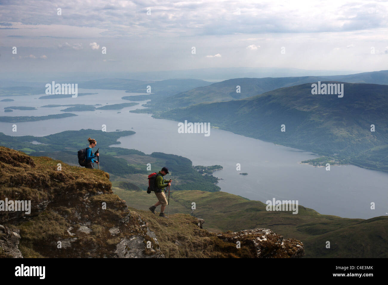 A pair of hillwalkers descending the Ptarmigan ridge on Ben Lomond in the Scottish highlands Stock Photo