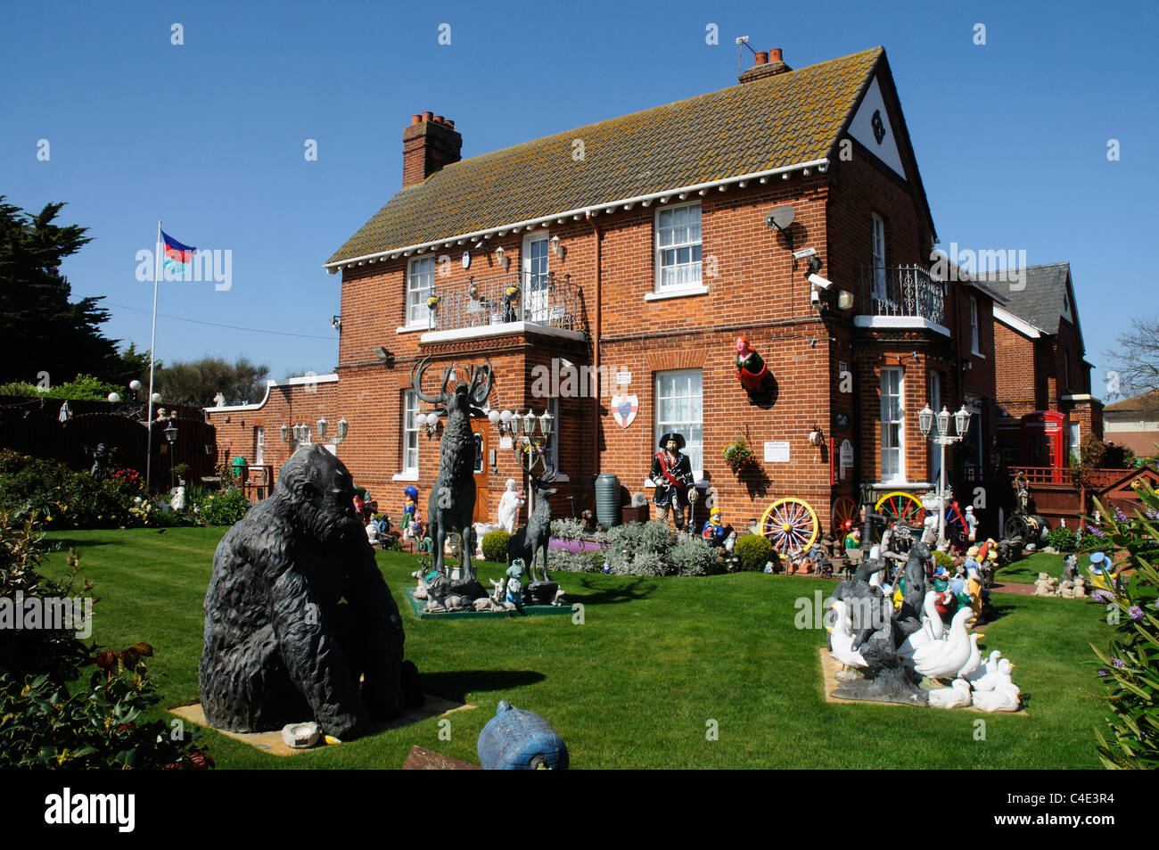 A house with lots of statues in the garden in Clacton Essex Stock Photo