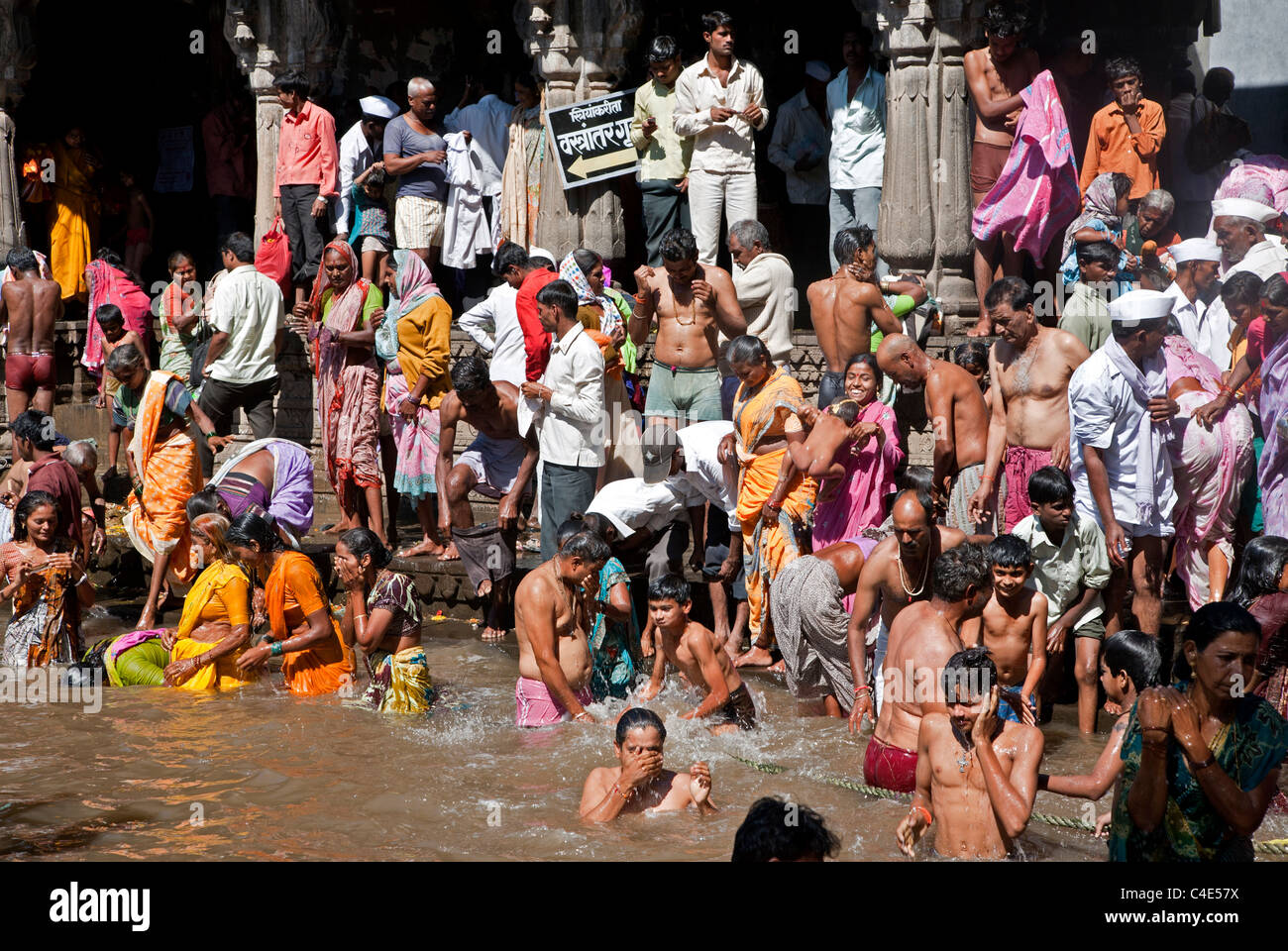 Hindu pilgrims bathing in the sacred  water reservoir of Kushavarta (the source of the Godavari river). Trimbakeshwar. India Stock Photo