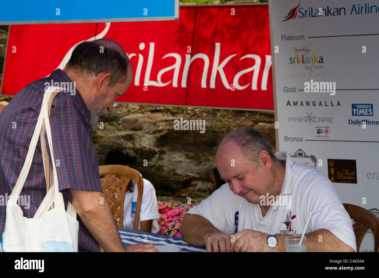 Louis de Bernières author of Captain Corelli's Mandolin signs autographs at the Galle Literary Festival, Sri Lanka. Stock Photo