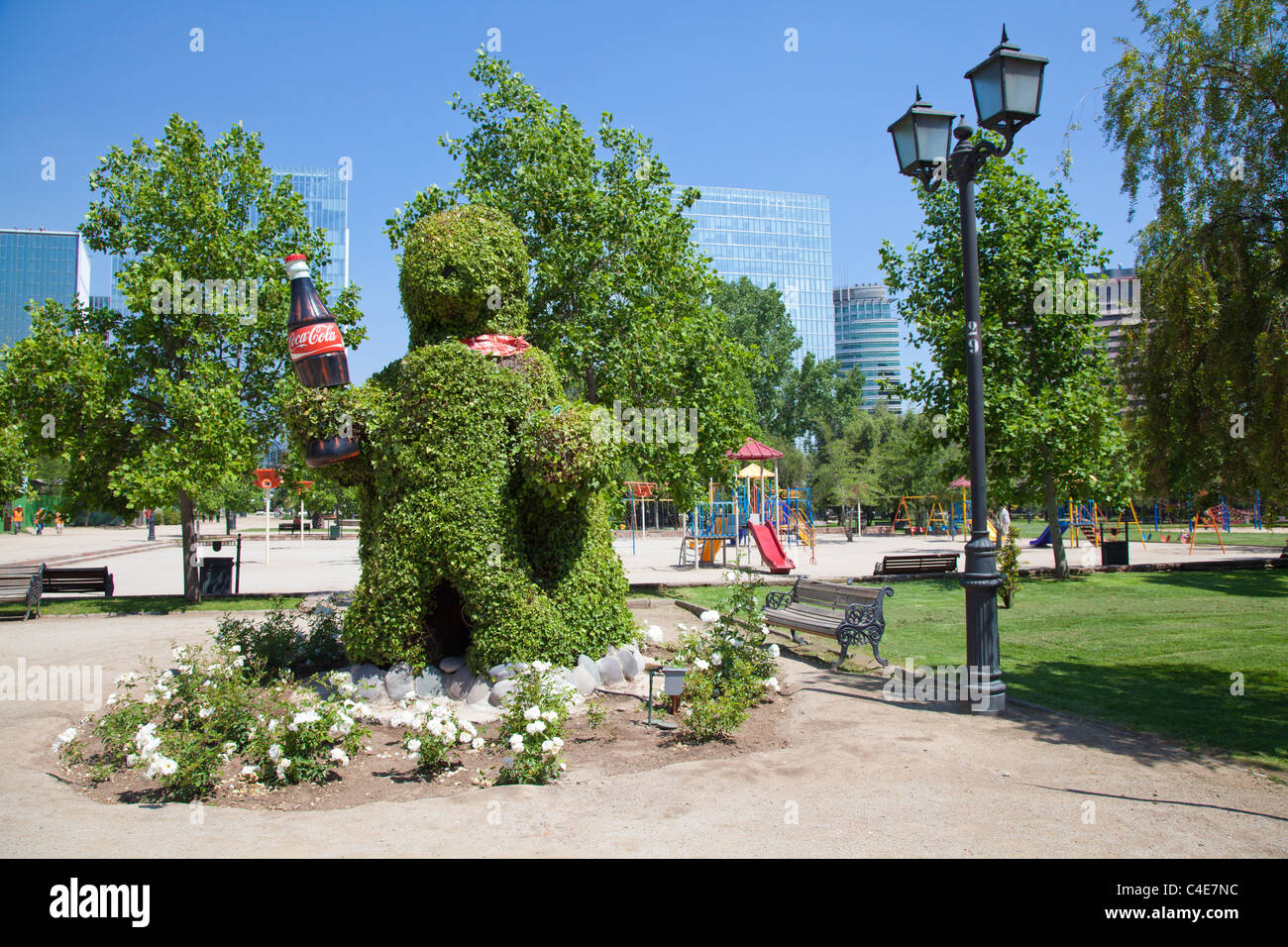 Topiary figure holding giant Coke bottle, Parque Arauco, Vitacura, Santiago, Chile Stock Photo