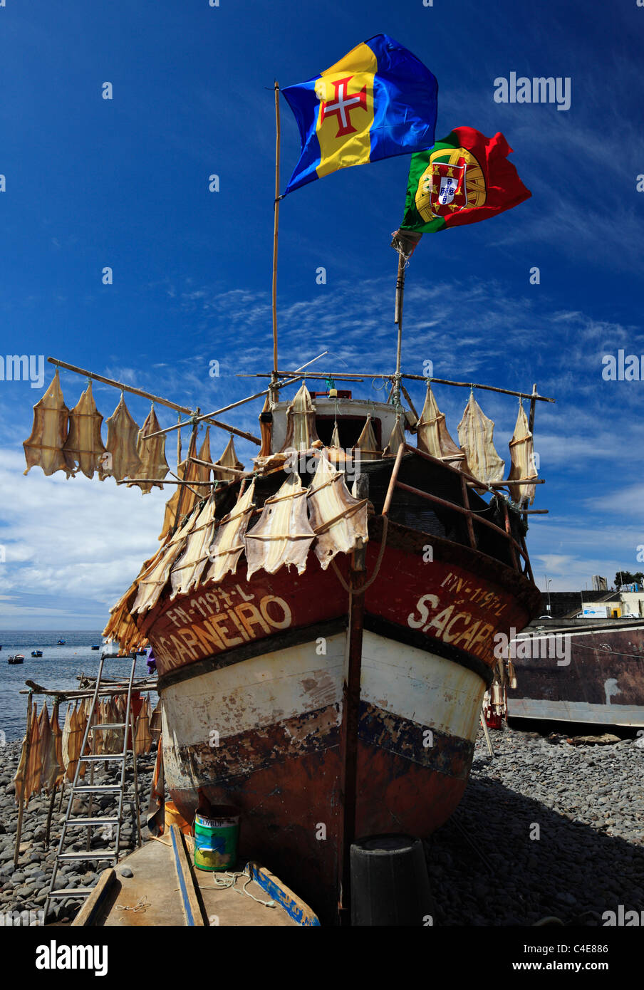 Fishing boat with drying fish displaying the flag of Portugal & Madeira. Stock Photo
