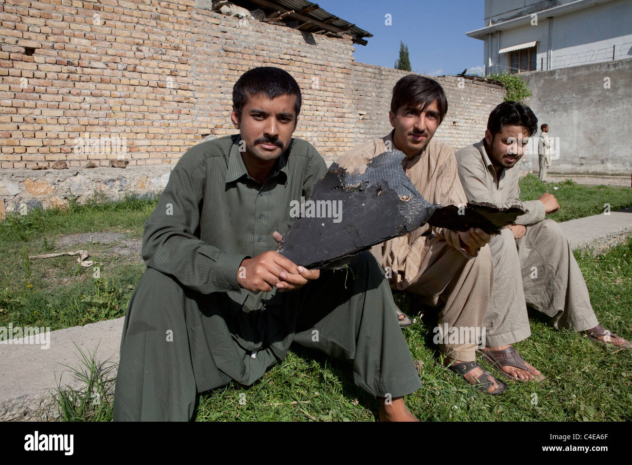 house in Abbottabad, pakistan where bin laden was killed, kids showing US helicopter pieces Stock Photo
