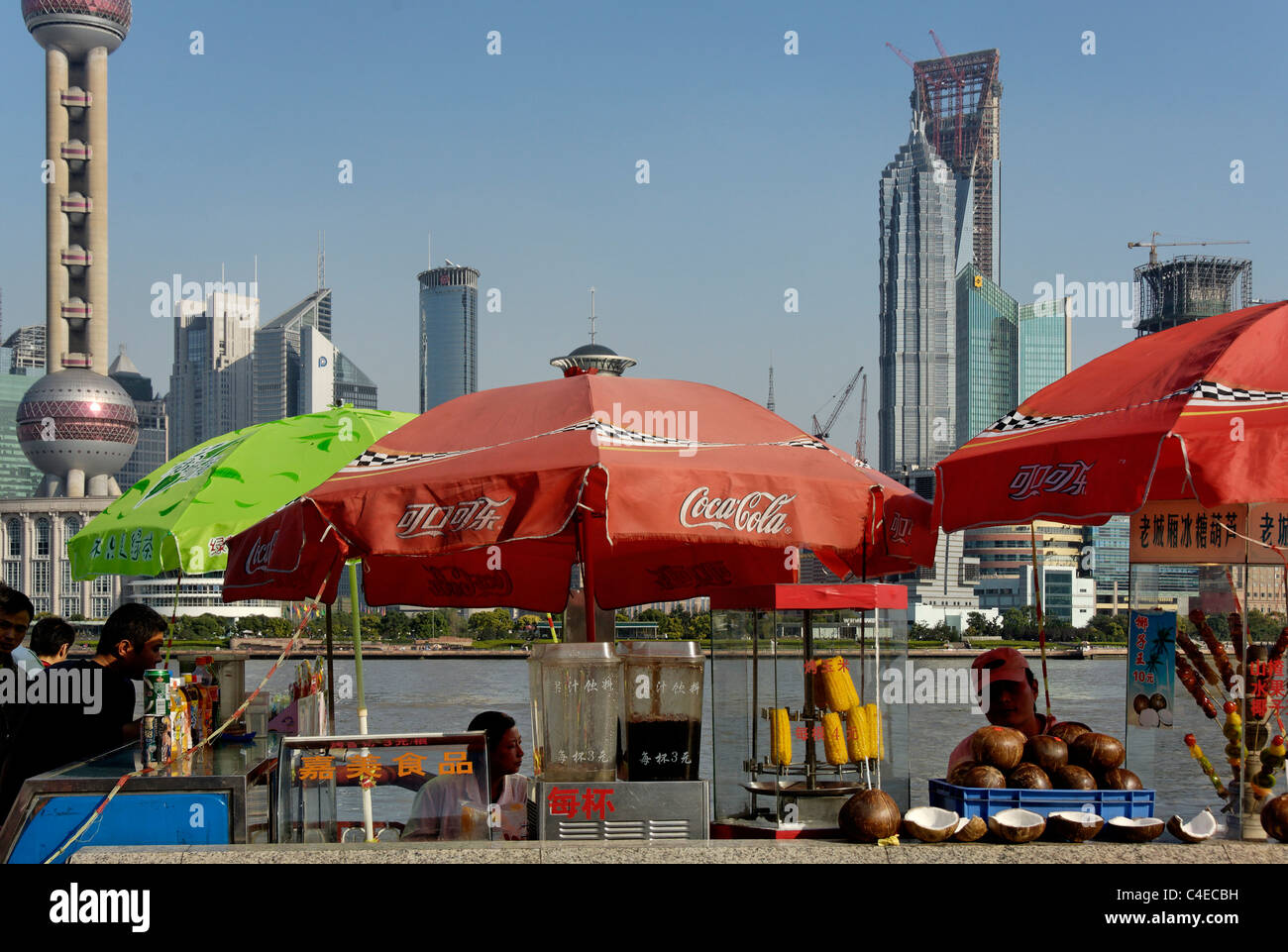People on the Bund, overlooking the Huangpu River and the Pudong skyline, Shanghai, China. Stock Photo