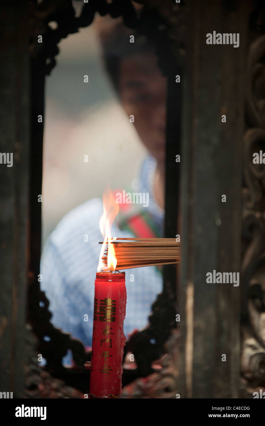 People making offerings at a temple on the island of Putuoshan, near Shanghai, China. Stock Photo