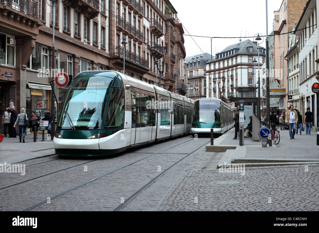 Modern trams at a tram stop on the Rue des Francs-Bourgeois, Strasbourg, France. Stock Photo
