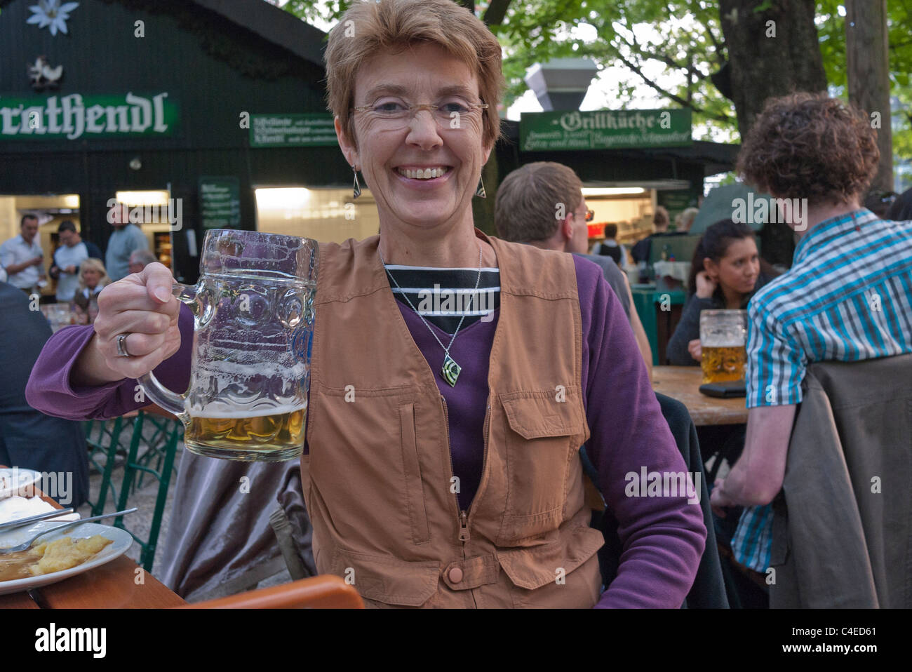 A female tourist drinks from a very large beer stein at the Augustiner-Keller beer garden in Munich, Germany. Stock Photo