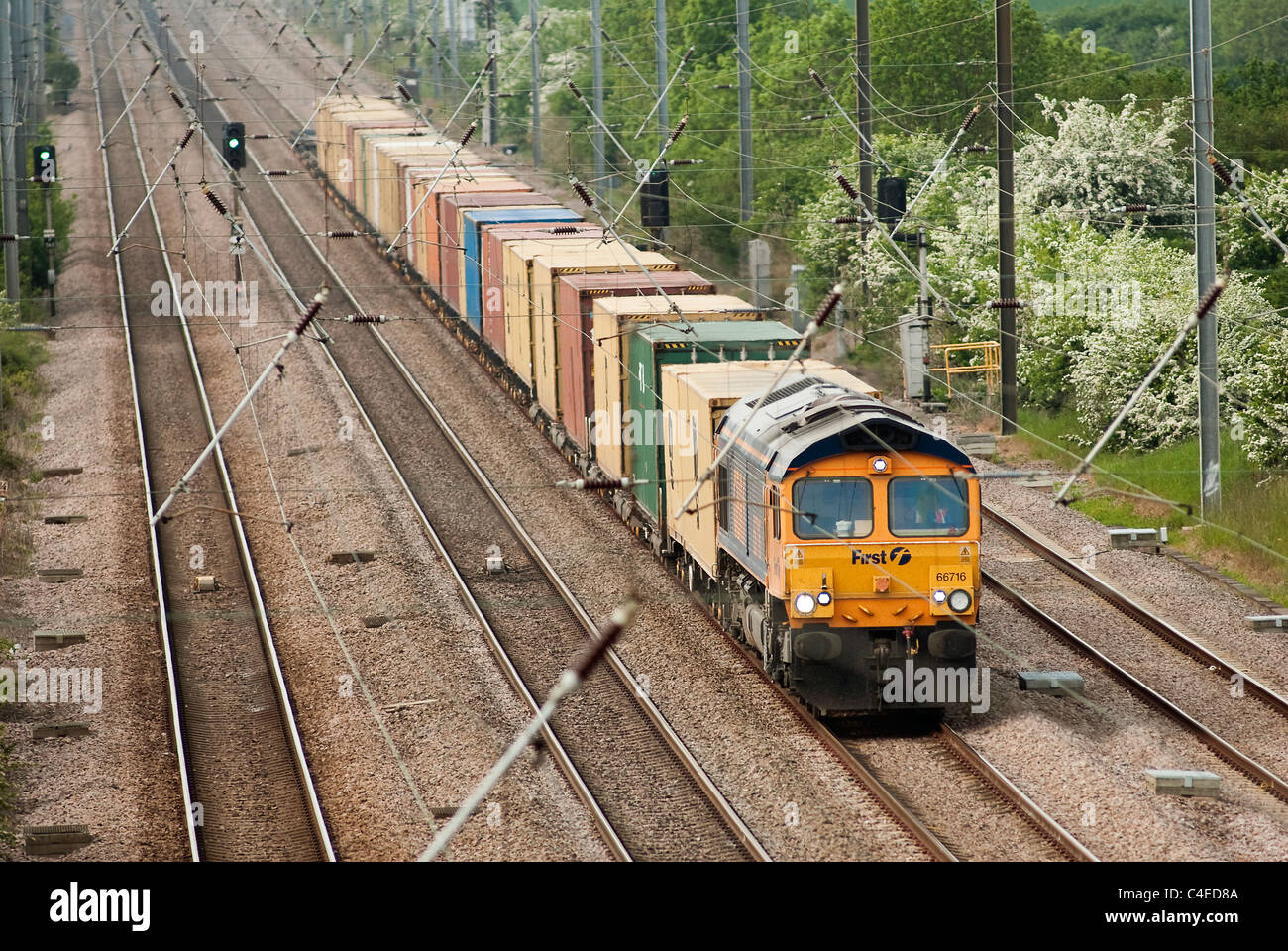 Class 66 freight locomotive in First GBRF livery hauling containers. Stock Photo