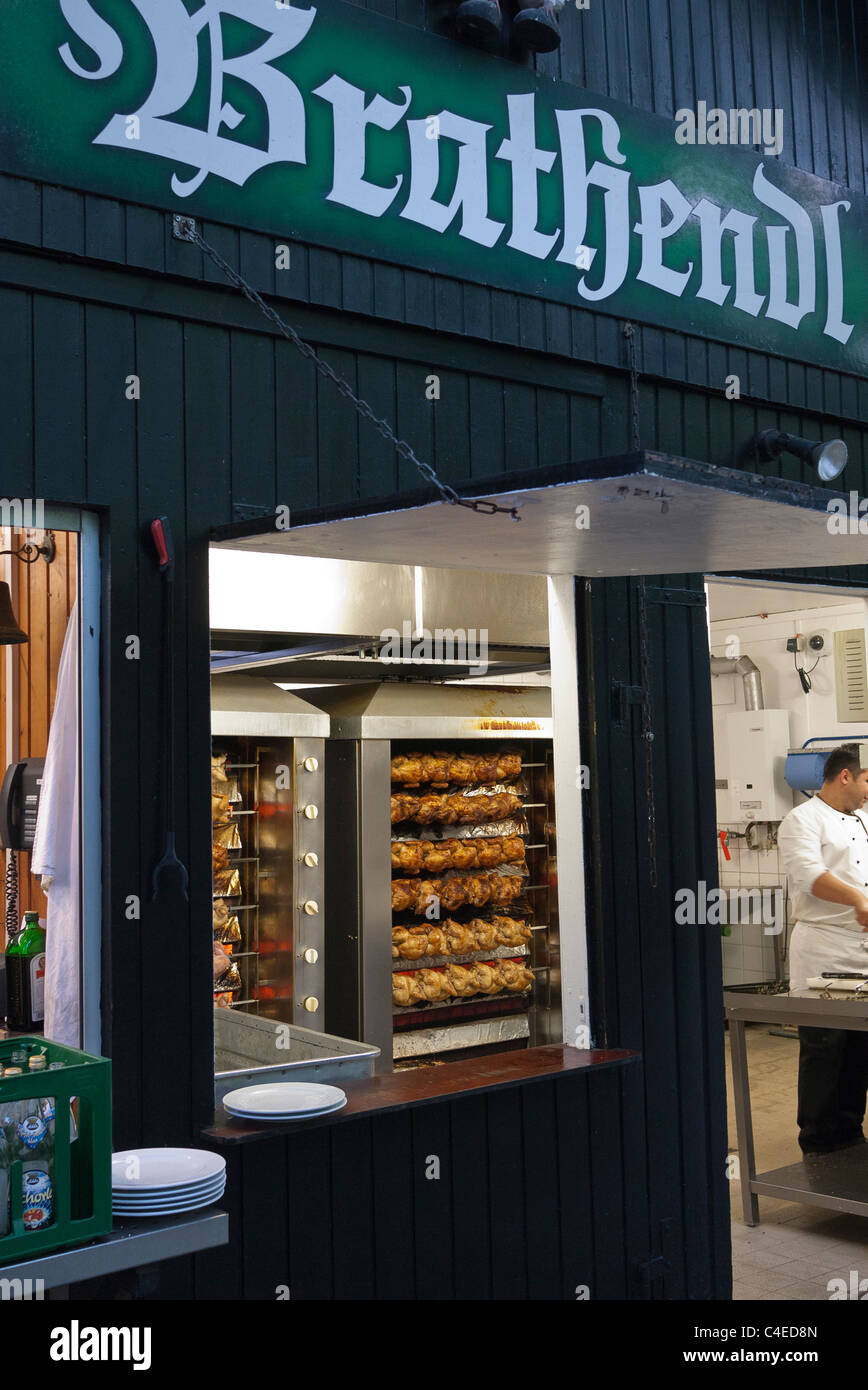 Large numbers of rotisserie chicken roast in the restaurant at the Augustiner-Keller beer garden in Munich, Germany. Stock Photo