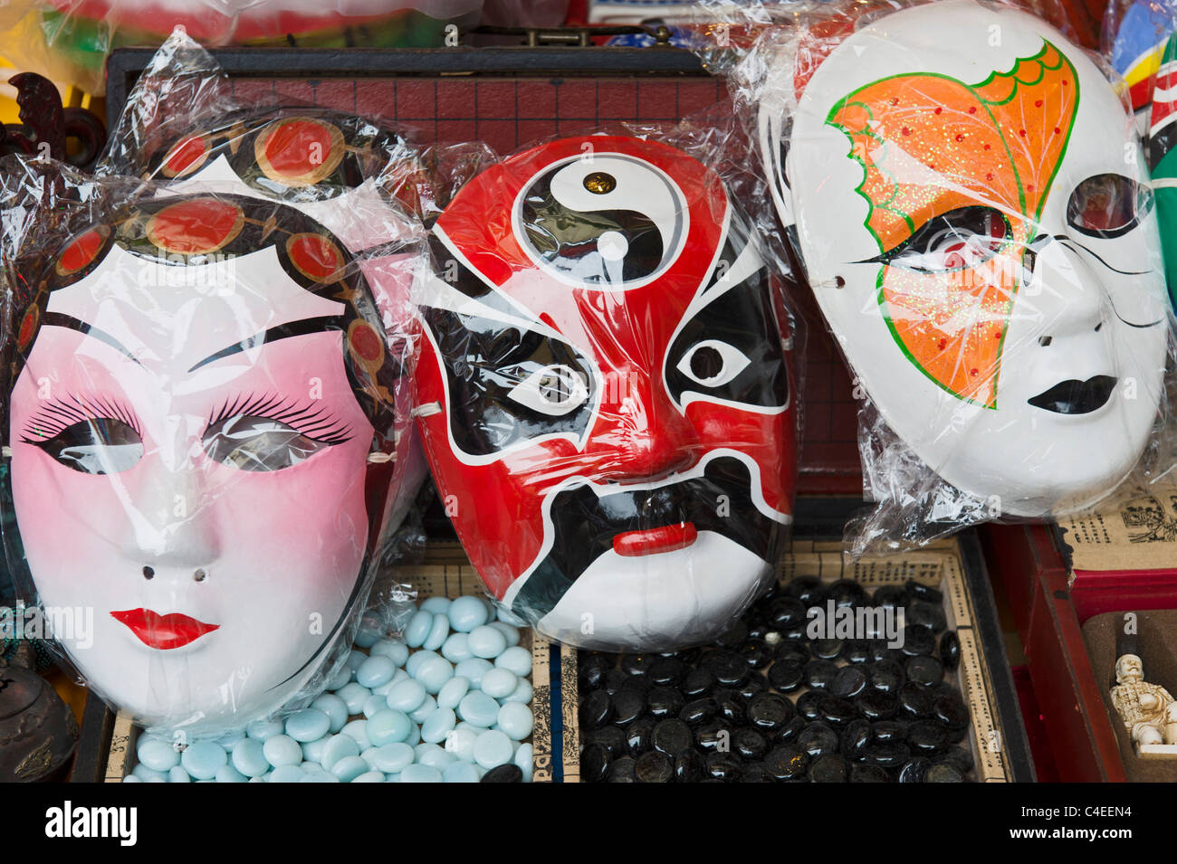Plastic Chinese opera masks for sale at Chenghuangmiao market. Shanghai, China Stock Photo