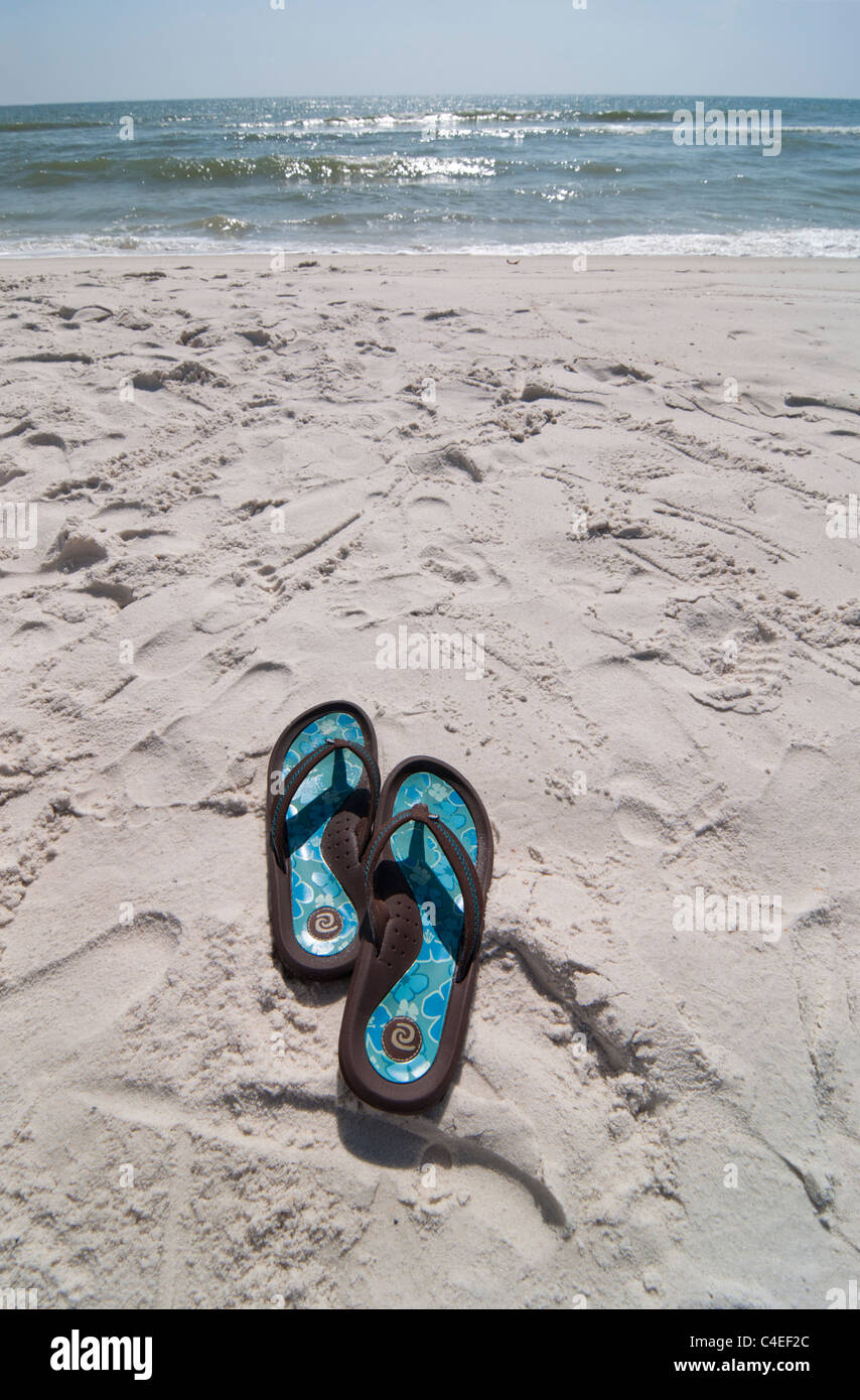 Gulf beaches along Florida's Panhandle at St. Joseph Peninsula State Park. flip flops shoes left behind in the sandy beach. Stock Photo