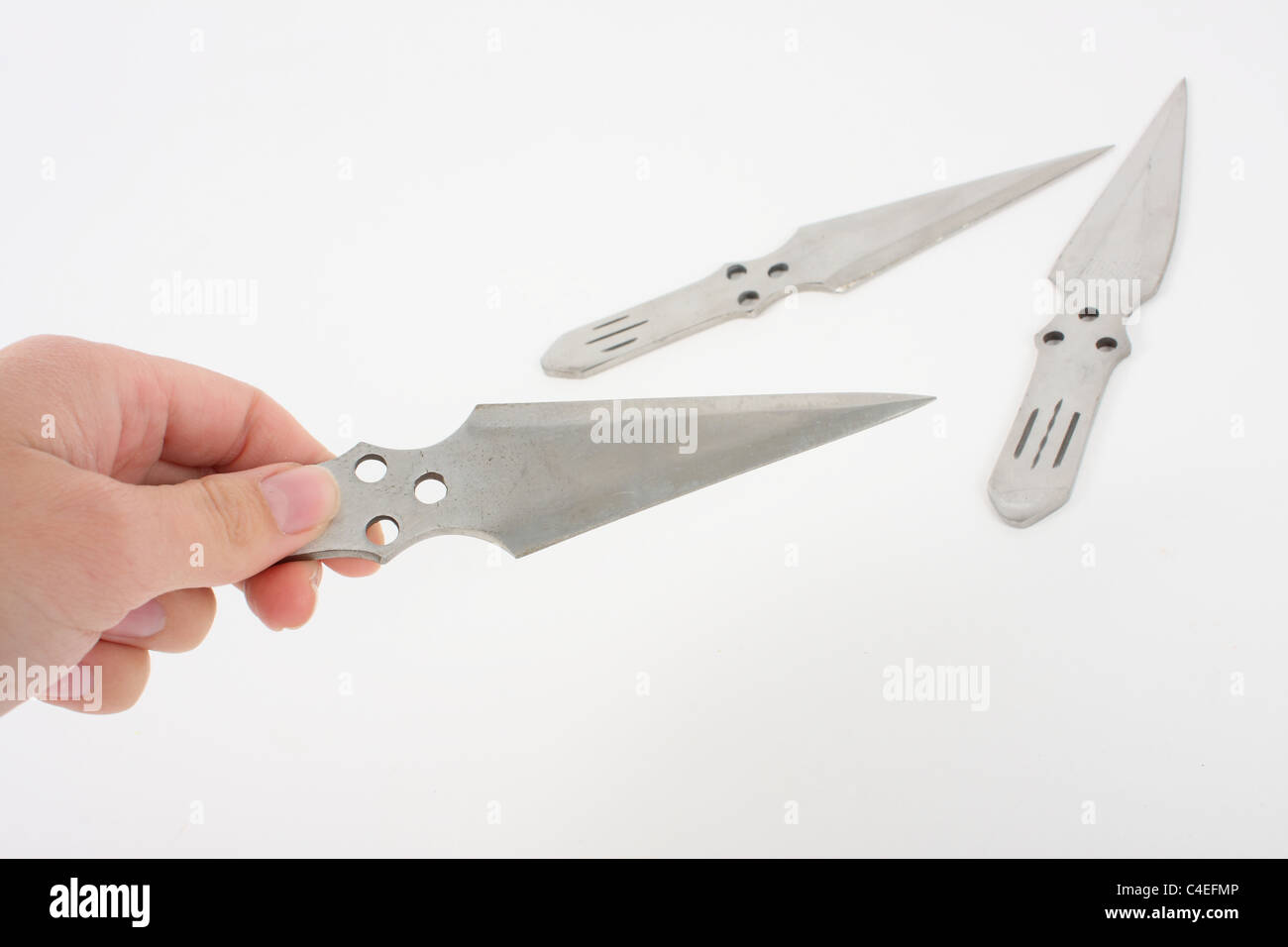 Holding a lock knife and demonstrating its use as a lethal weapon. A