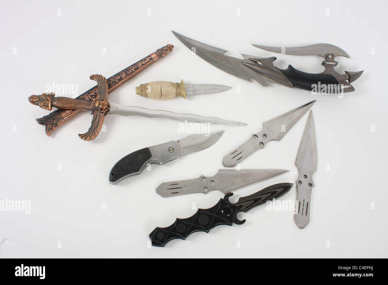 Holding a lock knife and demonstrating its use as a lethal weapon. A