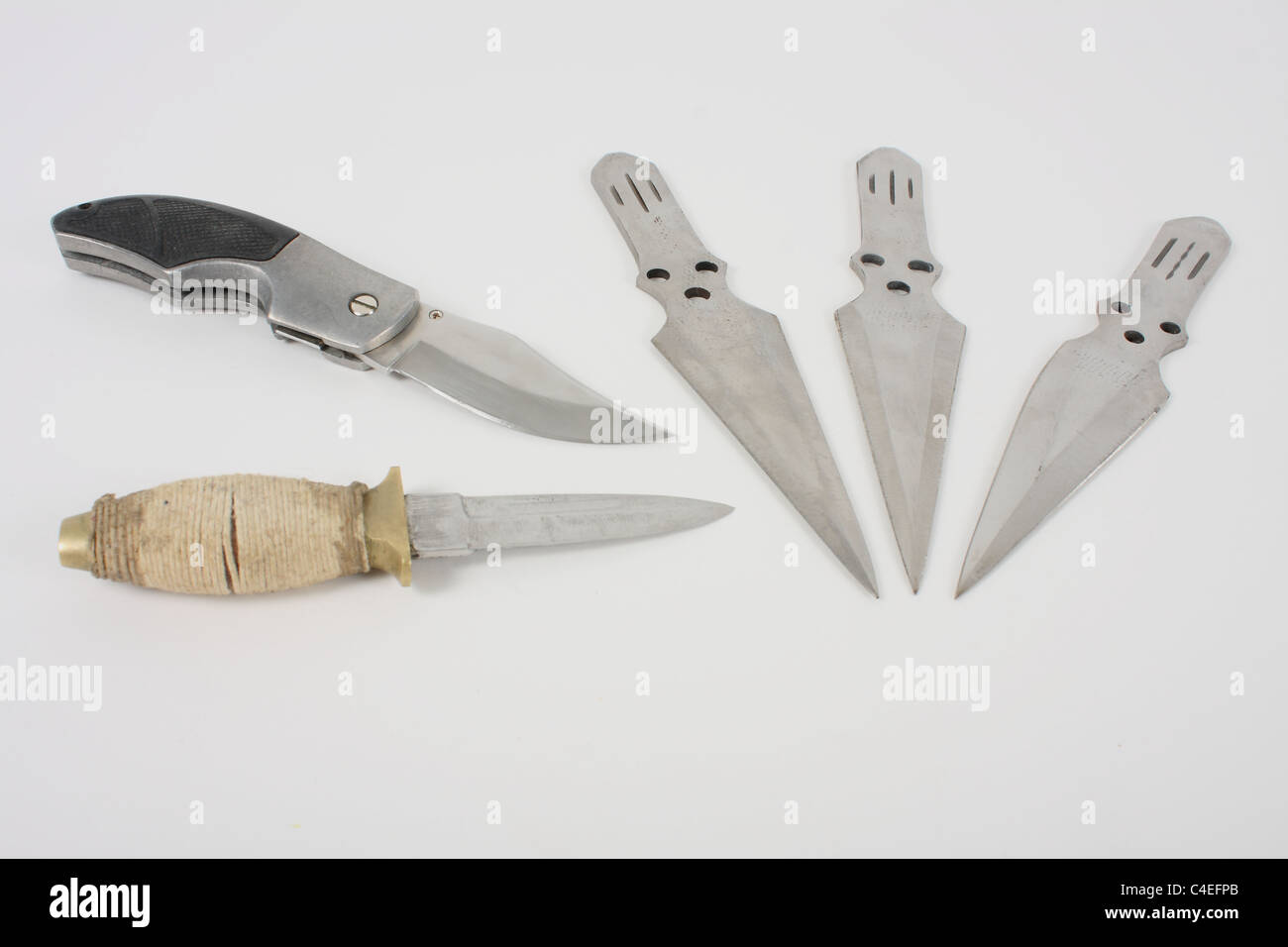 Holding a lock knife and demonstrating its use as a lethal weapon. A