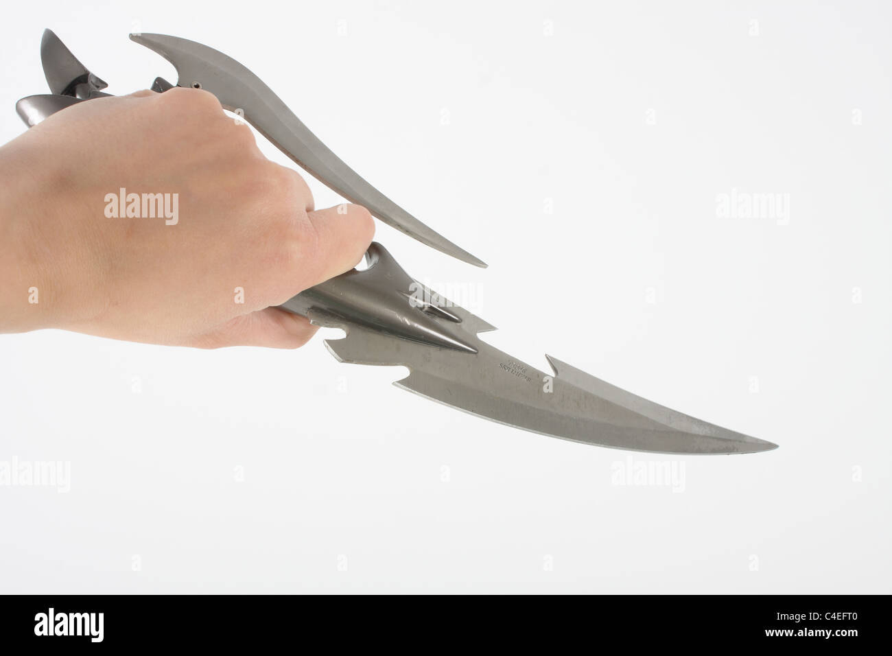 Holding a lock knife and demonstrating its use as a lethal weapon. A