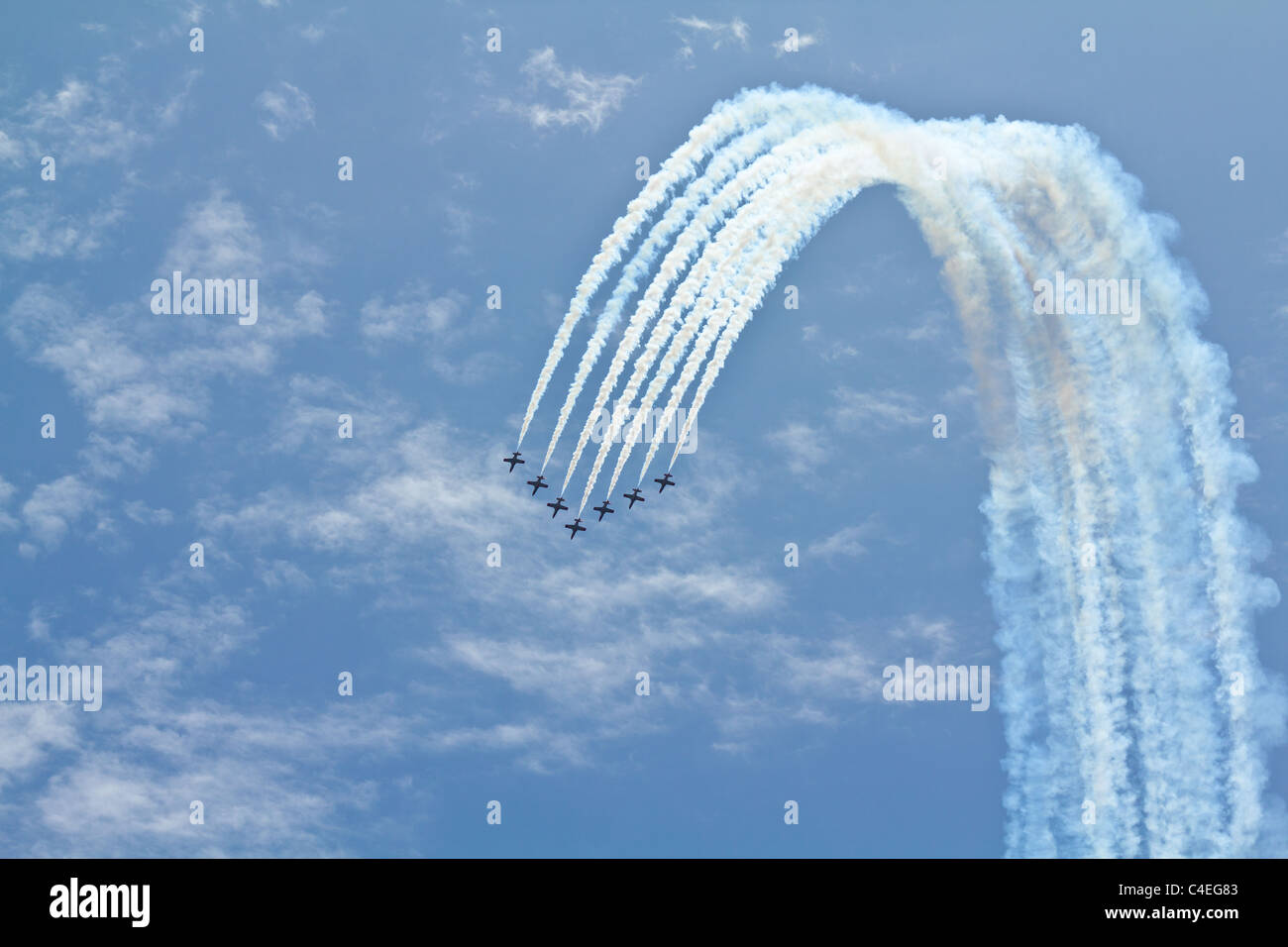 A Team Of Seven Airplanes Performing Difficult Maneuver On An Air Show 