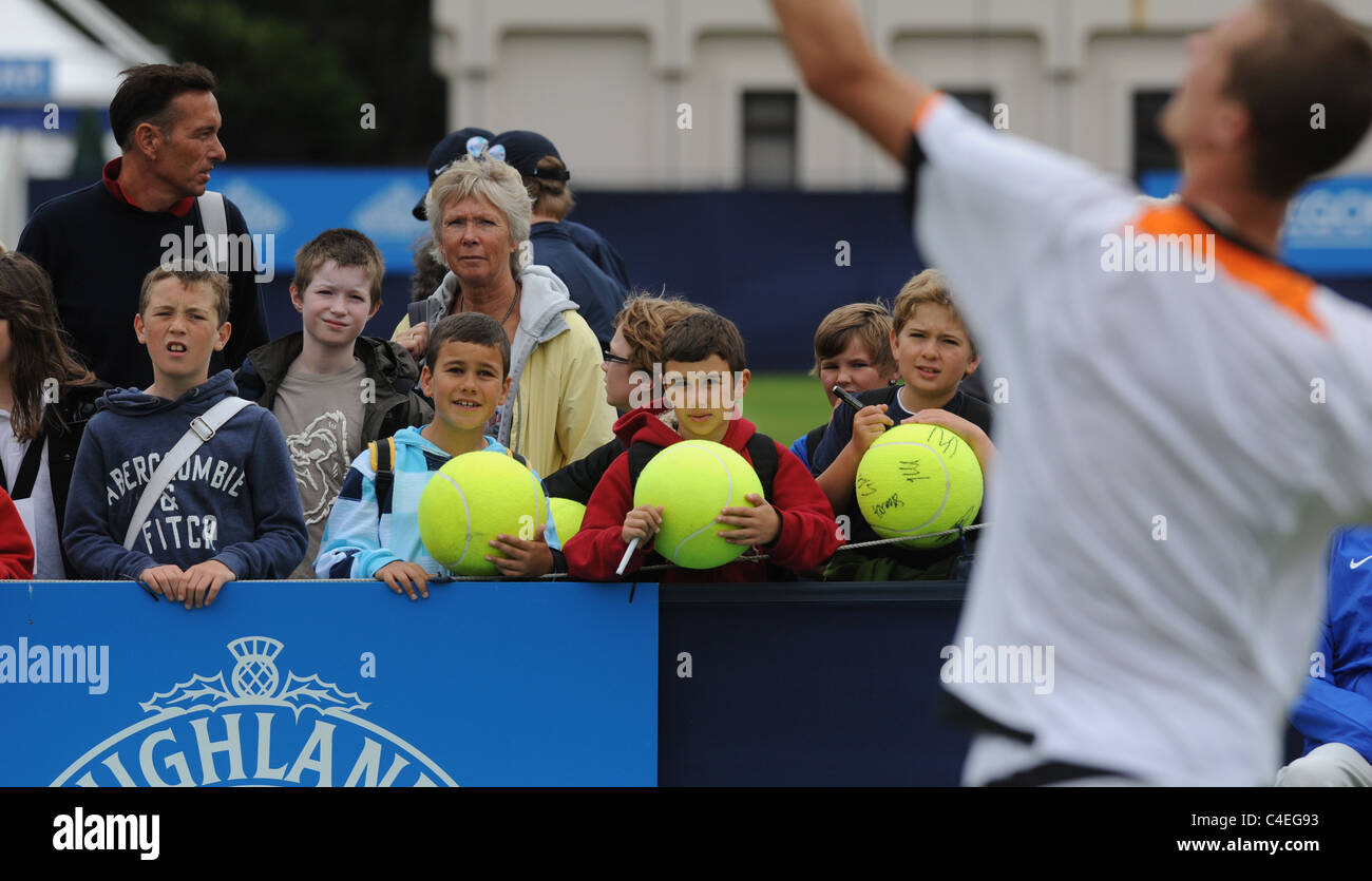 Children throw a ball back to the players at the Aegon International