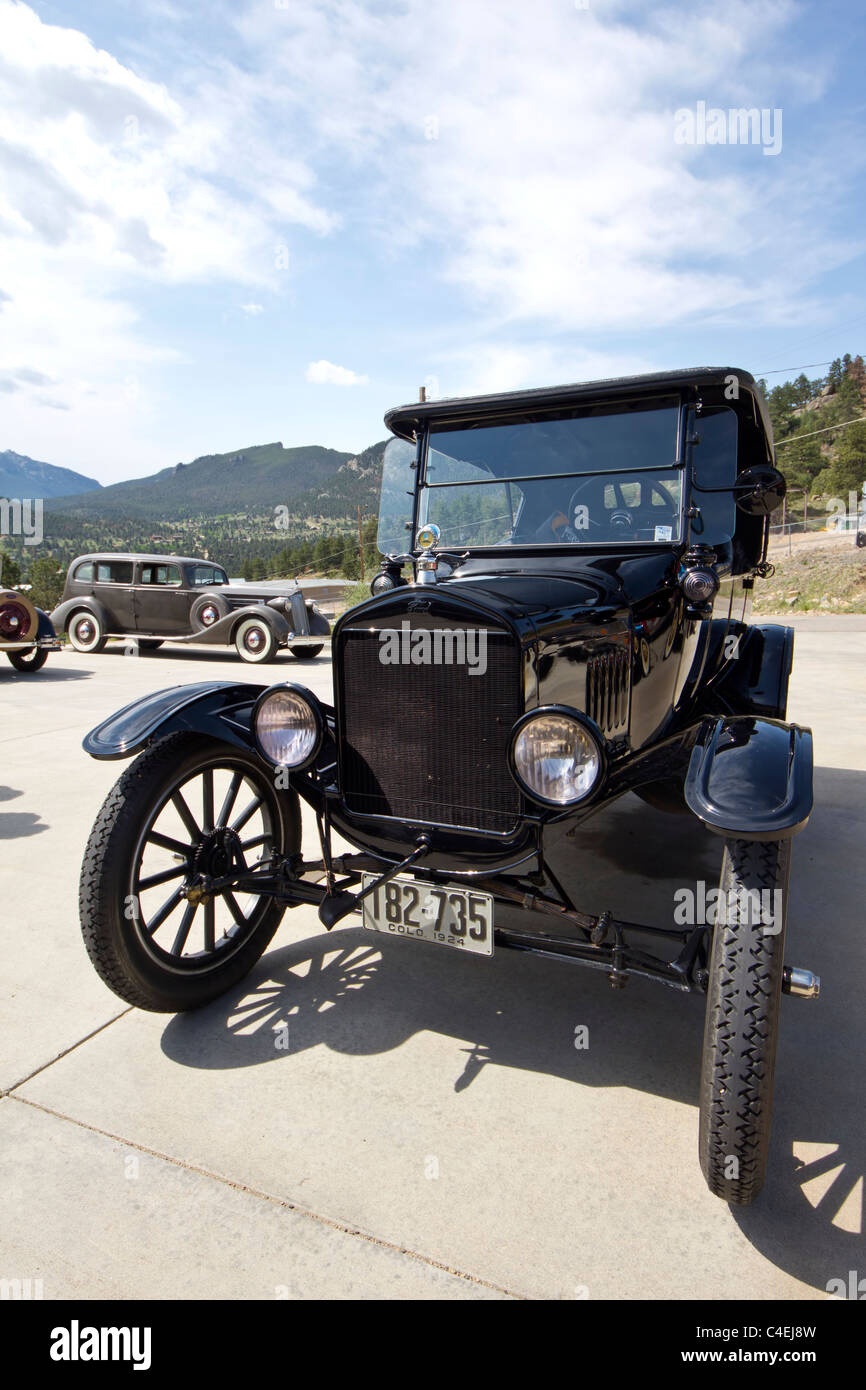 Estes Park, Colorado - A 1924 Model T Ford Sedan with a circa 1938 Packard in the background. Stock Photo