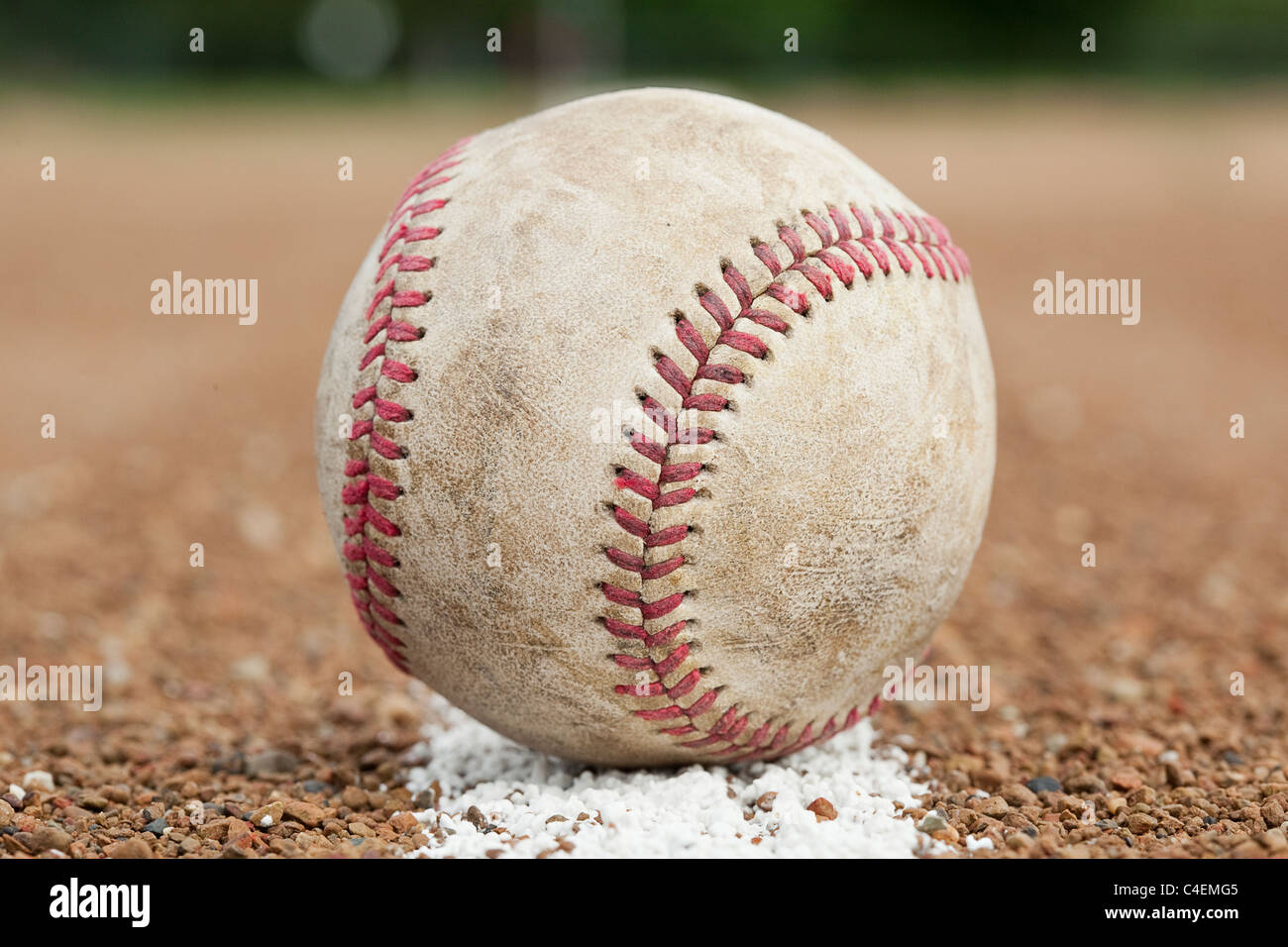 An old worn baseball on a baseball field Stock Photo - Alamy