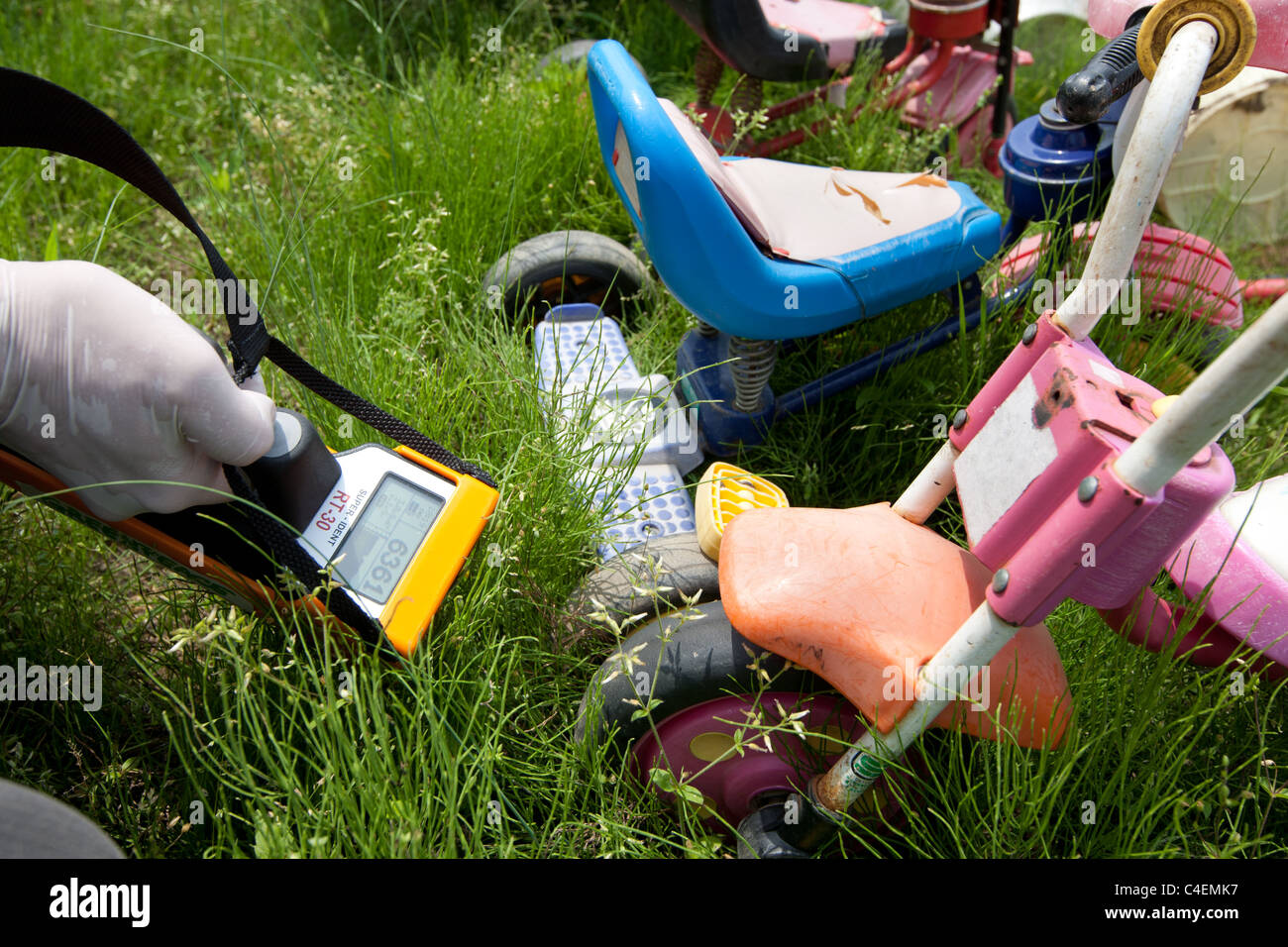 Workers undertake radiation contamination monitoring in the grounds of Children's Nursery, in Fukushima city, Japan. Stock Photo