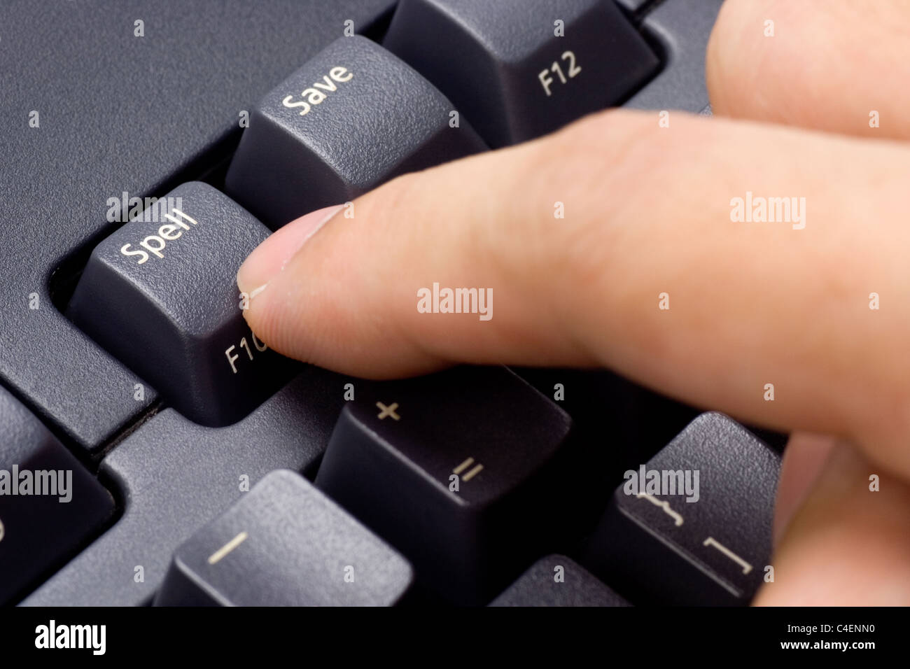 Closeup of a finger pressing SPELL button on a keyboard Stock Photo
