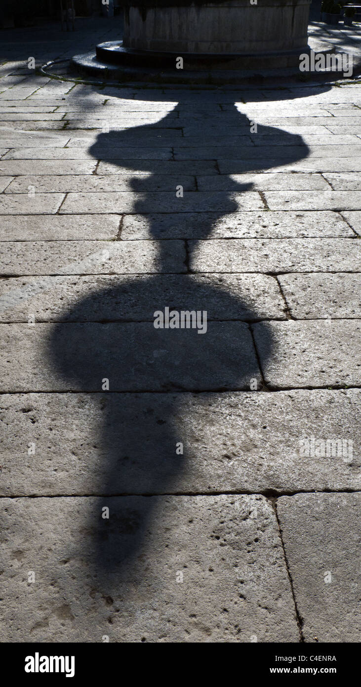 shadow of a fountain on the pavement Stock Photo