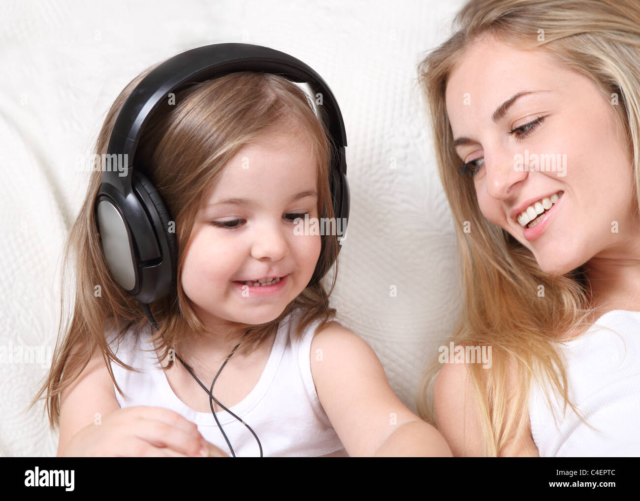 Mother and daughter listen to the music Stock Photo - Alamy