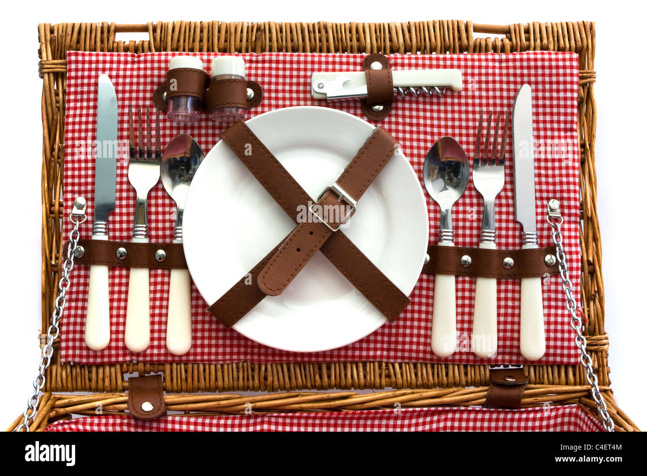 Old fasioned wicker picnic basket with cutlery Stock Photo