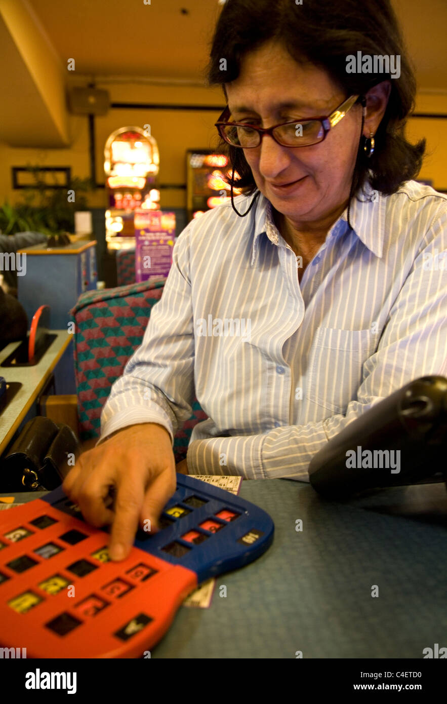 Woman playing table bingo at Beacon Bingo in London Stock Photo