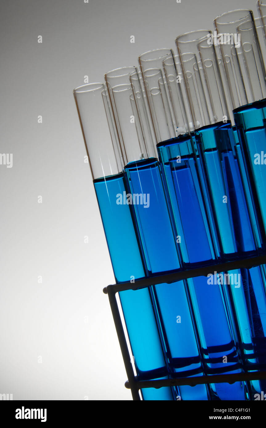 blue test tubes in a rack with white background Stock Photo - Alamy