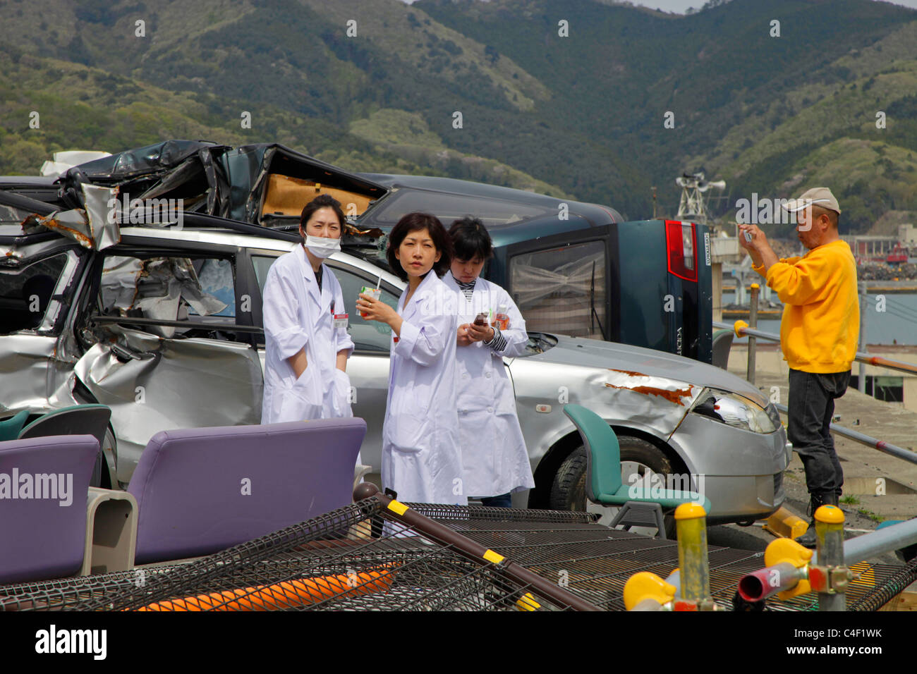 Nurses of Onagawa hospital looking down the town devastated by Tsunami 11th March 2011 Stock Photo