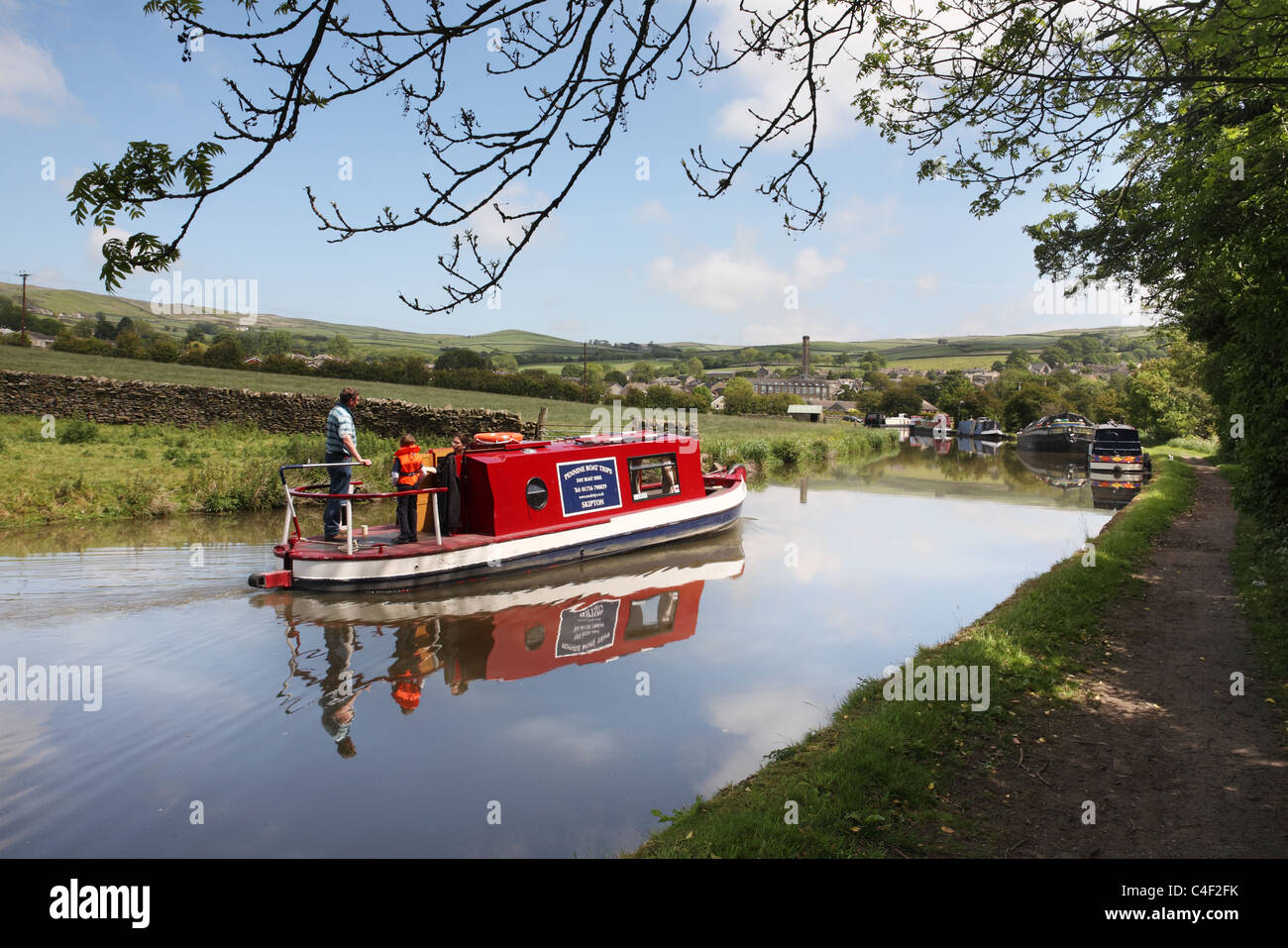 A family on a canal narrow boat on the Leeds and Liverpool canal near Skipton, Yorkshire, England, UK Stock Photo