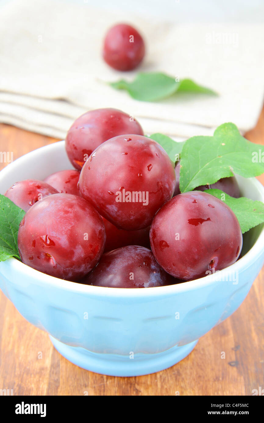 ripe, fresh red plums on the table Stock Photo