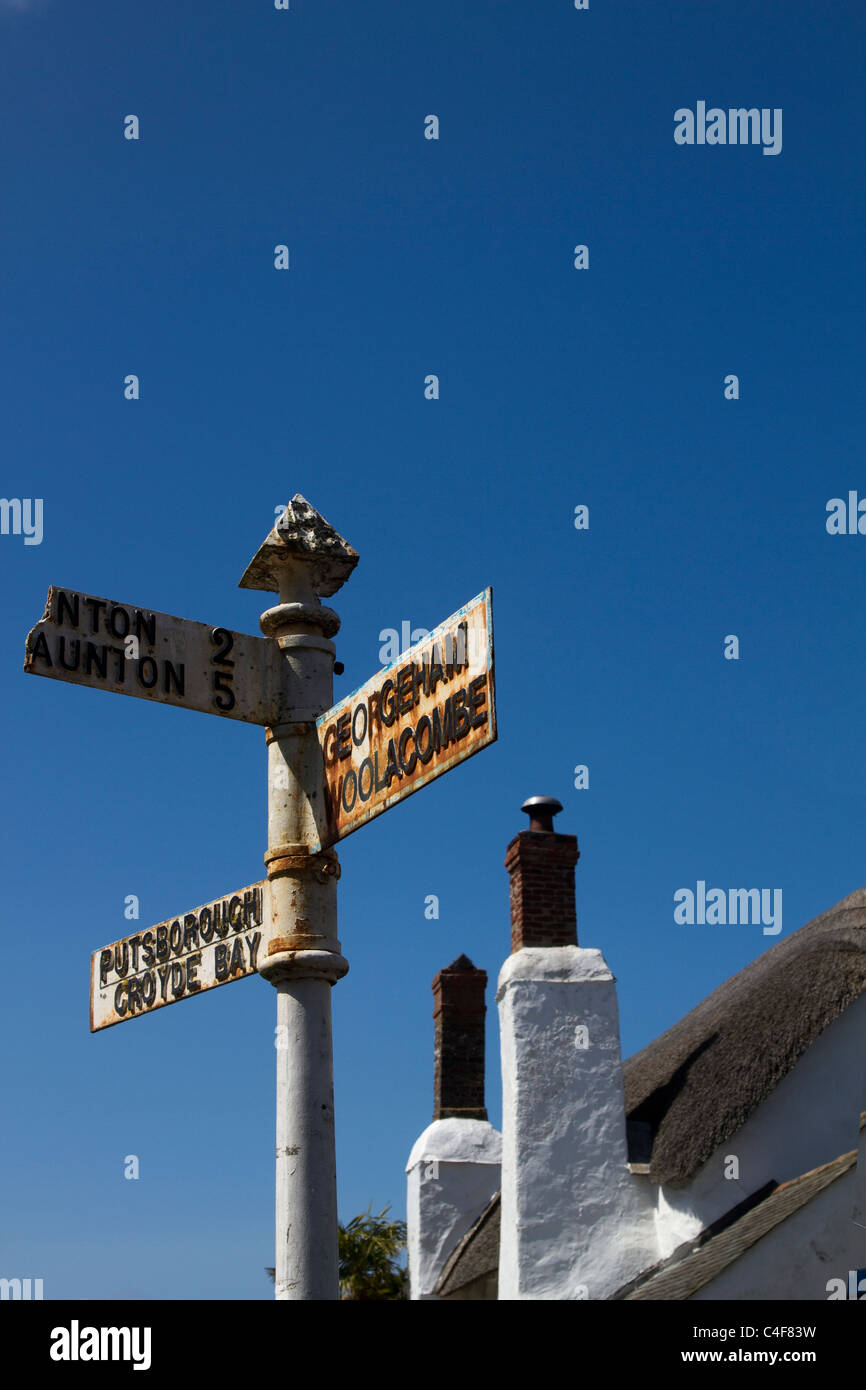 Georgeham, Woolacombe, Taunton, Croyde Bay. Old UK signpost, Street sign for different destinations. Thatched Cottage in North Devon, UK Stock Photo