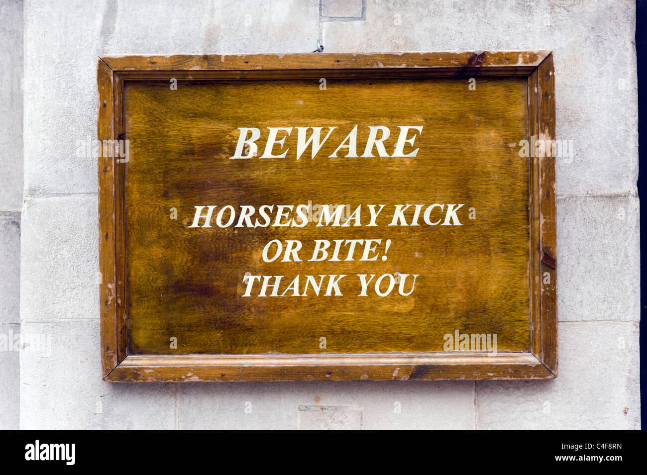 Beware, horses may kick or bite warning sign outside Horse Guards Parade on Whitehall, London, UK Stock Photo