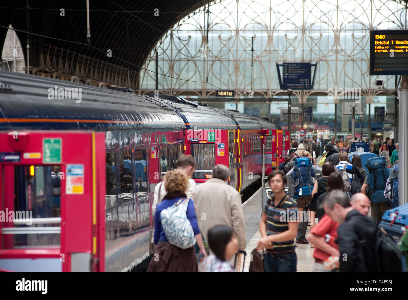 Passengers getting off of a train at Paddington station, London