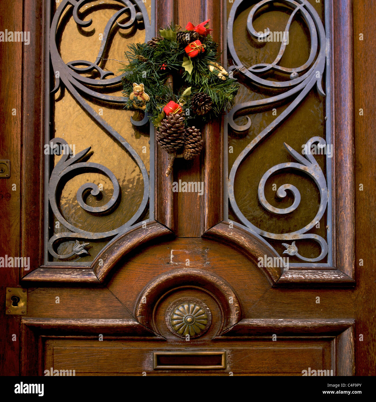 Christmas wreath on a brown front door. Stock Photo