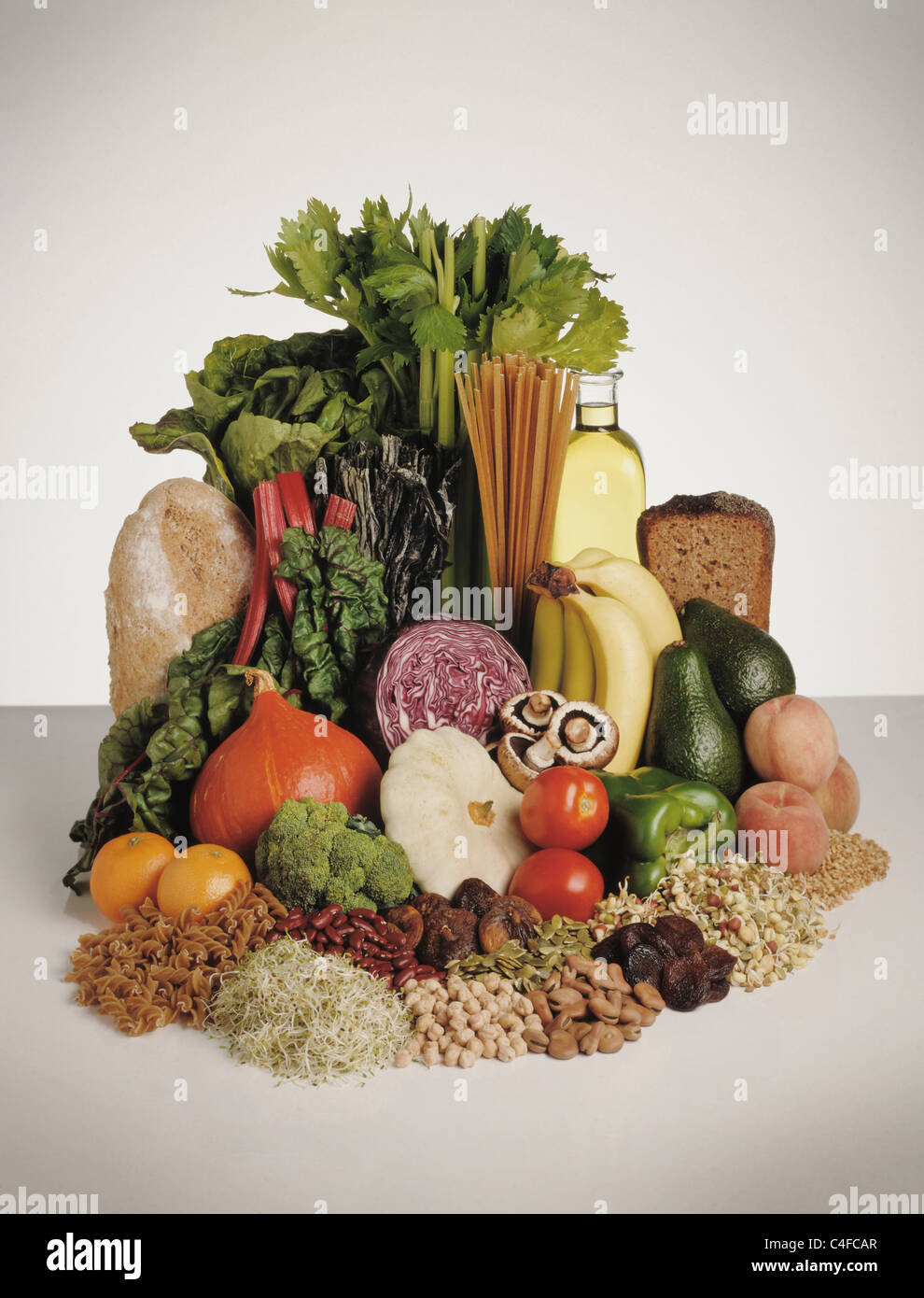 Display of healthy foods, fruits, vegetables, pulses, pasta and bread. Stock Photo