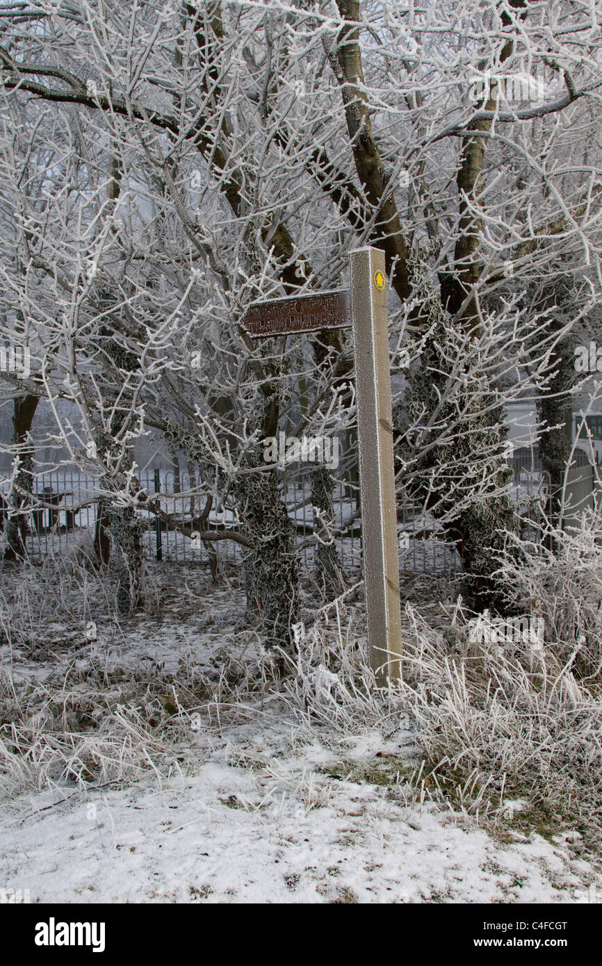 Waymark fingerpost on footpath in snow and frost Stock Photo