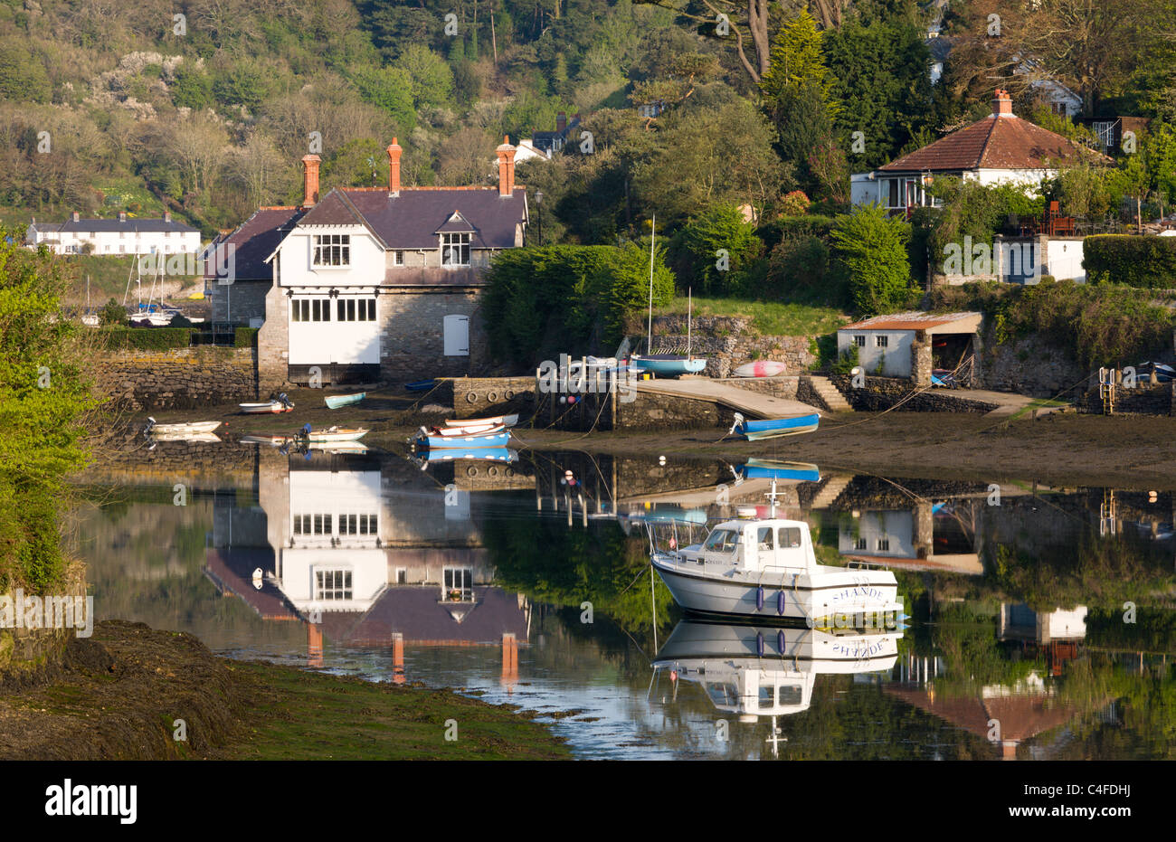 Boats and houses beside the River Yealm in the picturesque South Hams village of Newton Ferrers, Devon, England. Stock Photo