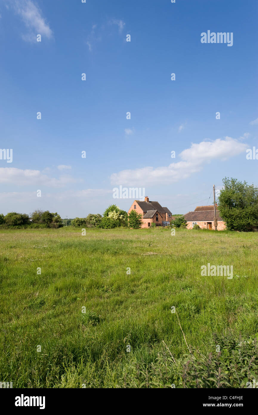 Property backing onto an open field in Aldington, Warwickshire, England, UK Stock Photo
