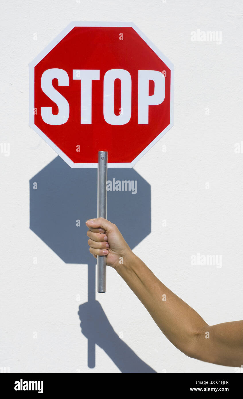Hand holding stop sign Stock Photo
