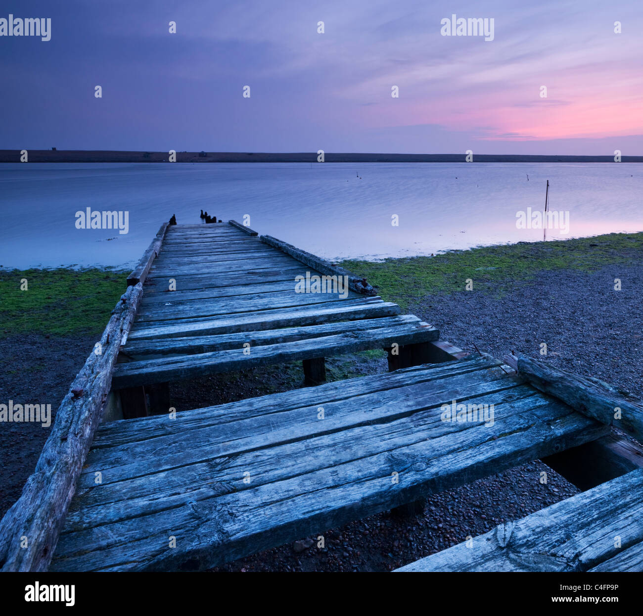 Run down wooden jetty on The Fleet lagoon, looking towards Chesil Beach