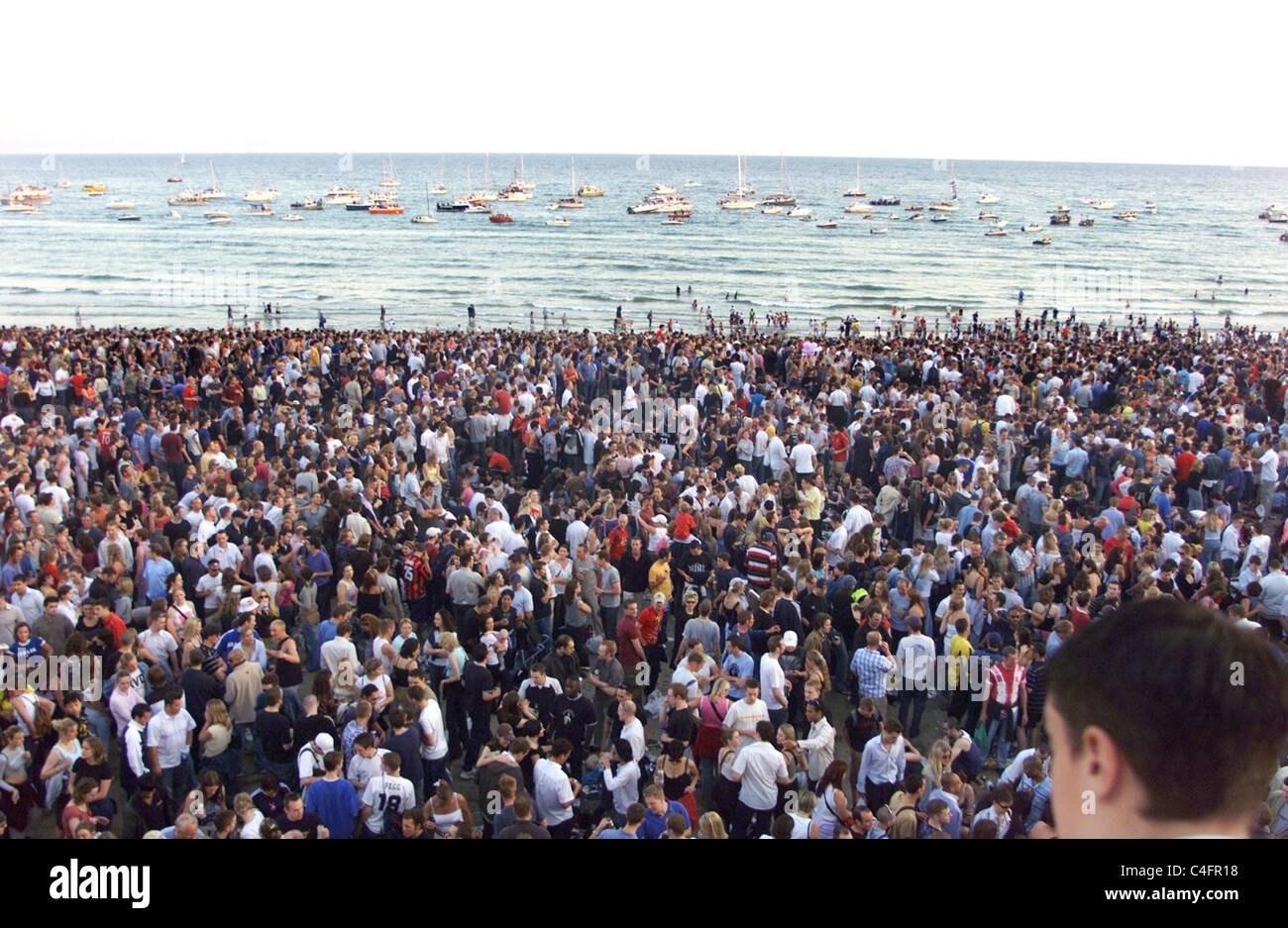 Hundreds of boats moored at sea get some of the best views for the Fat Boy Slim Beach Party July 2002 Stock Photo