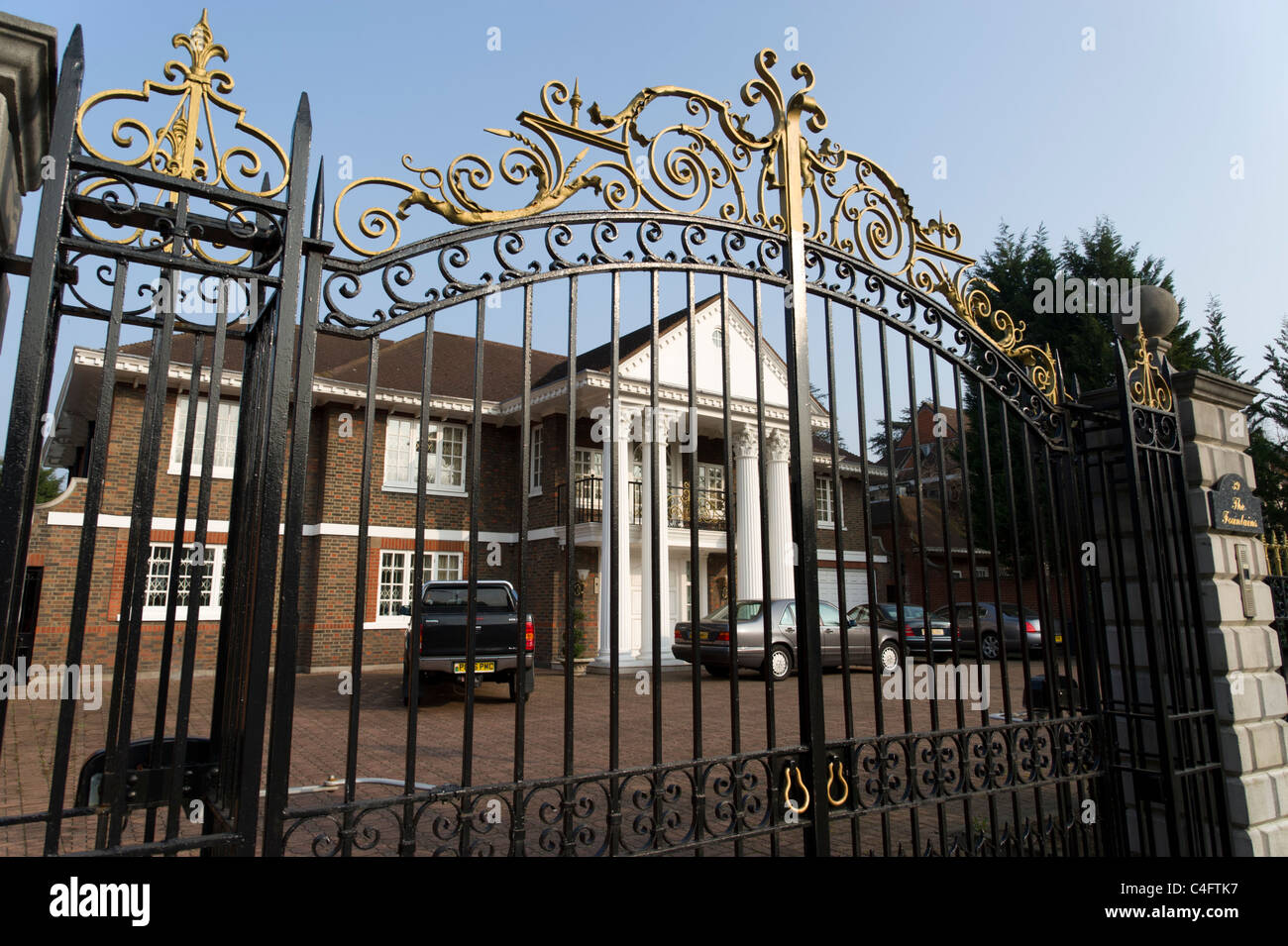 Large house behind metal gates on Avenue, London, UK Stock